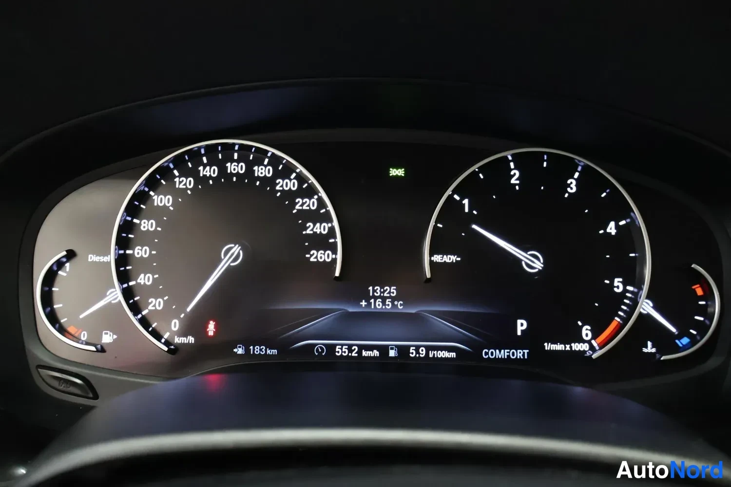 Yksityiskohta: BMW:n mittaristo: nopeusmittari, kierroslukumittari ja polttoainemittari, näytössä 55,2 km/h ja 5,9 l/100 km.