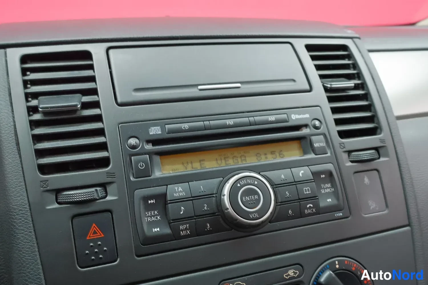 Yksityiskohta: Kojelauta: Nissan-radio USB-portilla, Bluetooth-merkinnällä, CD-toiminnolla ja näytöllä teksti YLE VEGA 8:56