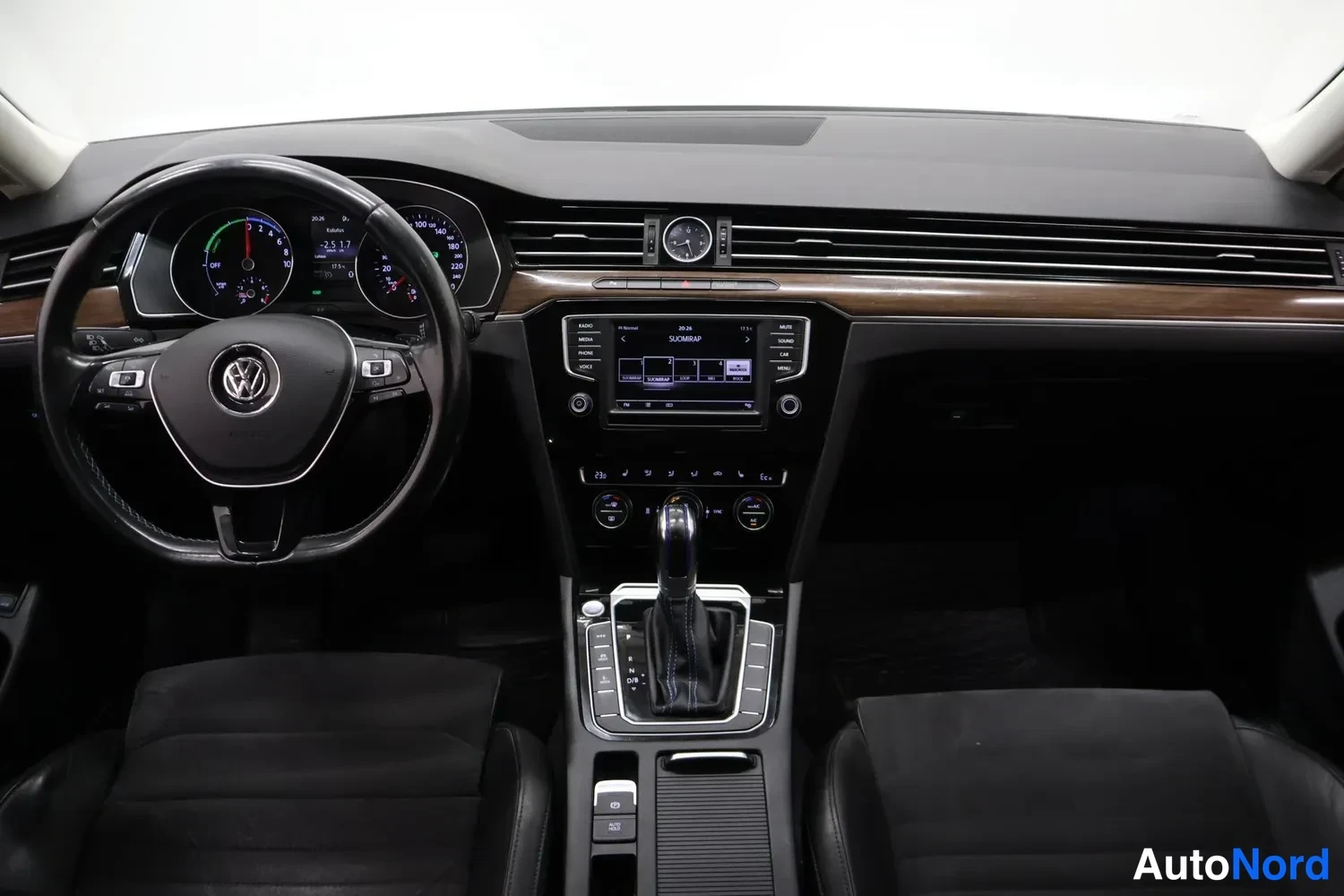 Yksityiskohta: Ohjaamo näkyvissä: Volkswagen-ohjauspyörä, hallintapaneeli, automaattivaihteen valitsin ja kosketusnäyttö keskilaitteistossa.