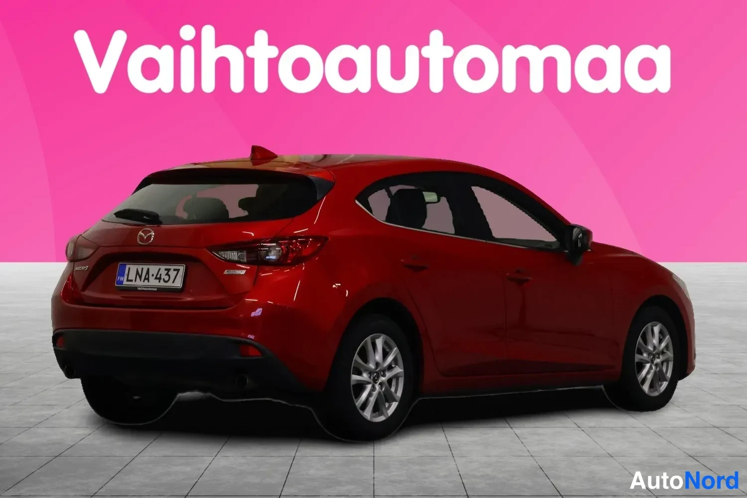 Takaviisto: Punaisen Mazda 3 -auto takapuoli ja oikea kylki