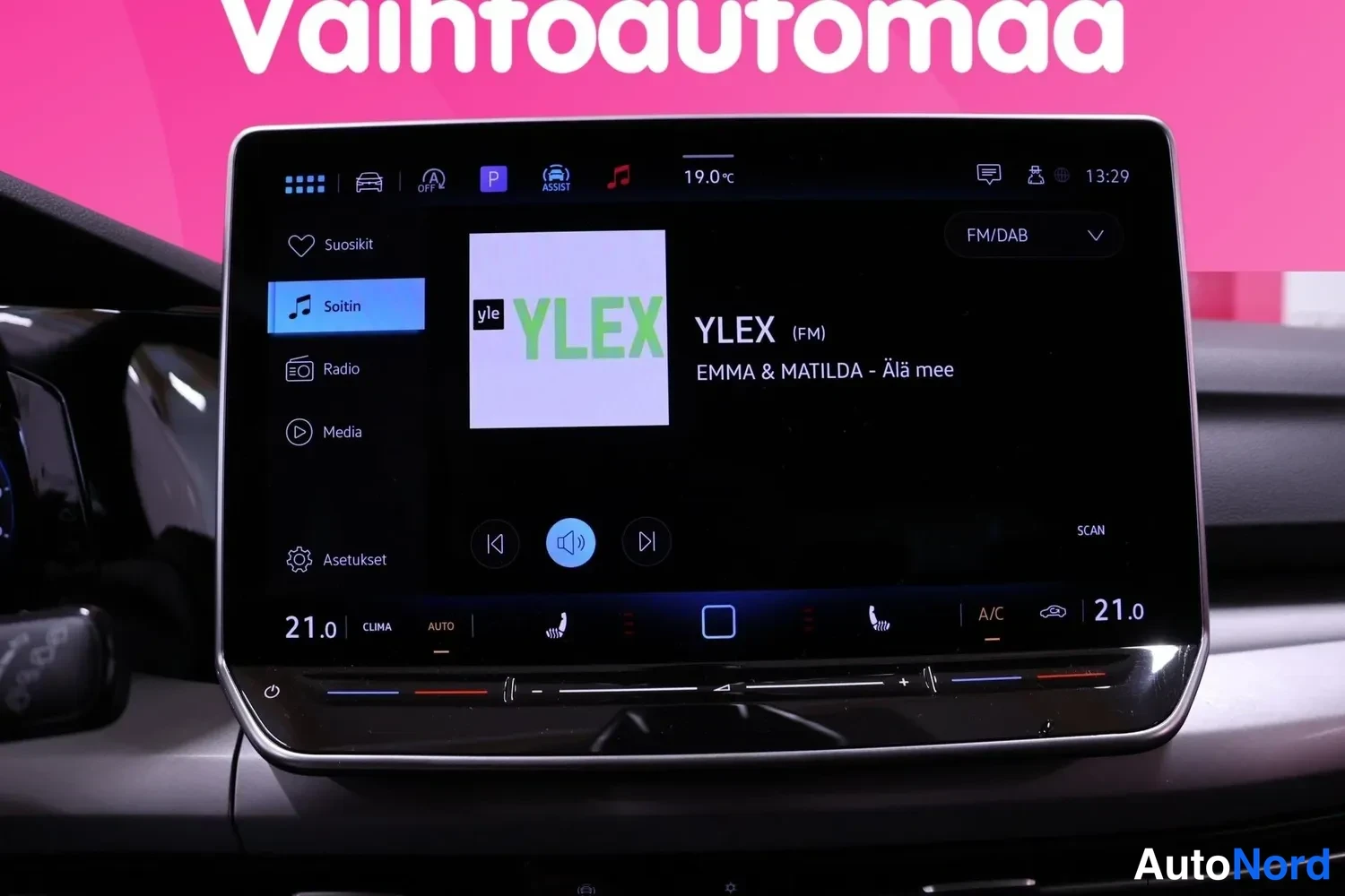 Yksityiskohta: Auton infotainment-näyttö, jossa soi YLEX-radio (kappale: EMMA & MATILDA – Älä mee).