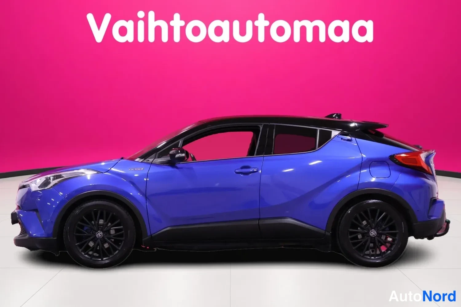 Takaviisto: Sininen Toyota C-HR sivulta kuvattuna, mustat kevytmetallivanteet ja musta katto