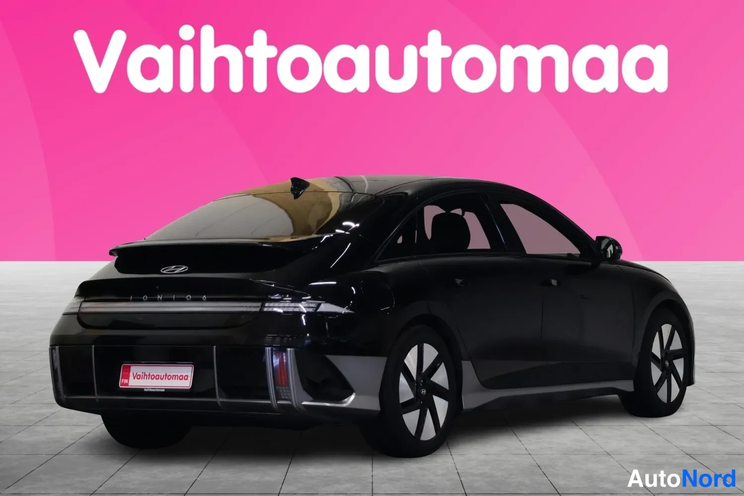 Takaviisto: Mustan Hyundai Ioniq 6:n takakulmakuva oikealta, perä ja oikea kylki näkyvissä studiossa.