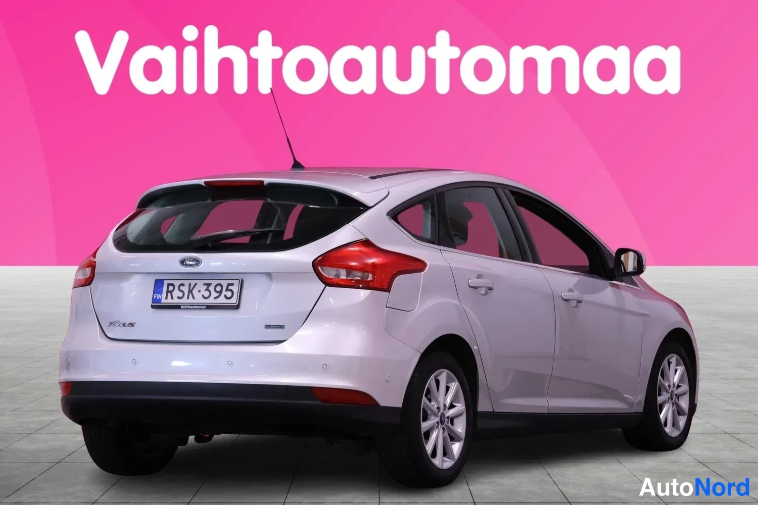 Takaviisto: Hopeanvärinen Ford Focus -viistoperä takaa vasemmalta, takaosa ja vasen kylki näkyvissä, rekisteritunnus.