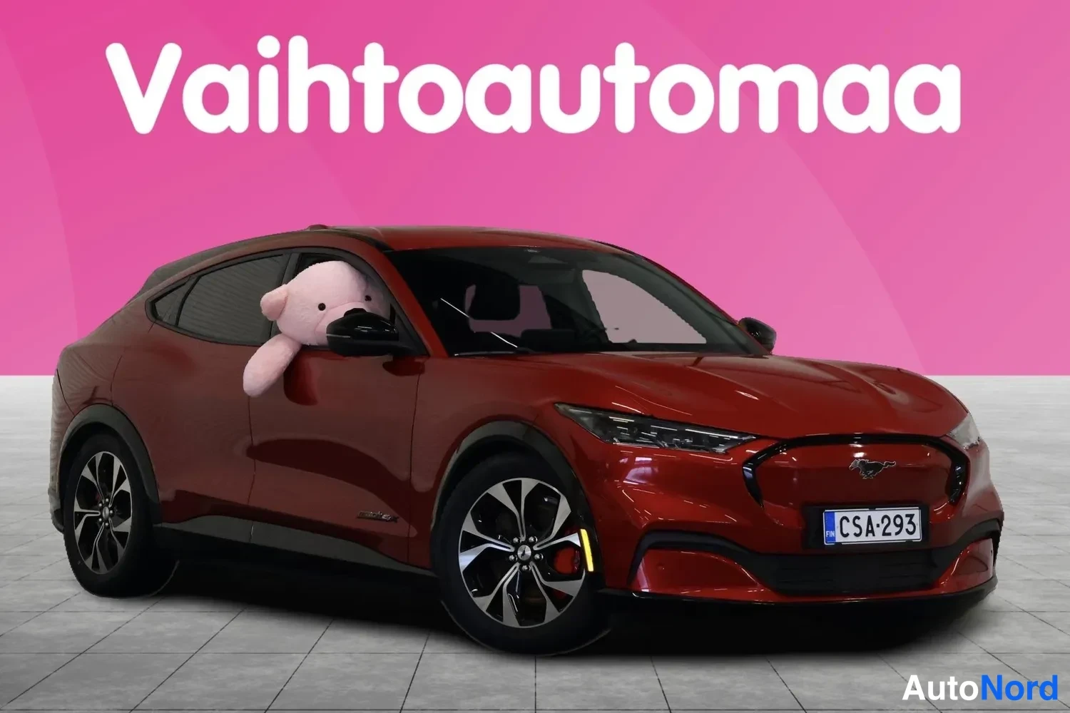 Etuviisto, nokka oikealle: Punainen Ford Mustang Mach-E etu-ja sivunäkymässä, etupää oikealla, rekisterissä.