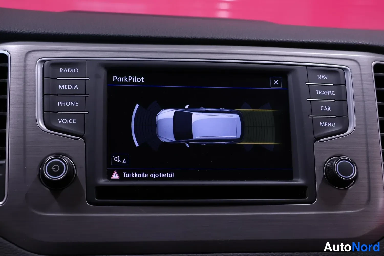 Yksityiskohta: Kojelaudan infotainment-näyttö näyttää ParkPilot-törmäystushärityn ja auton mallipohjaa.