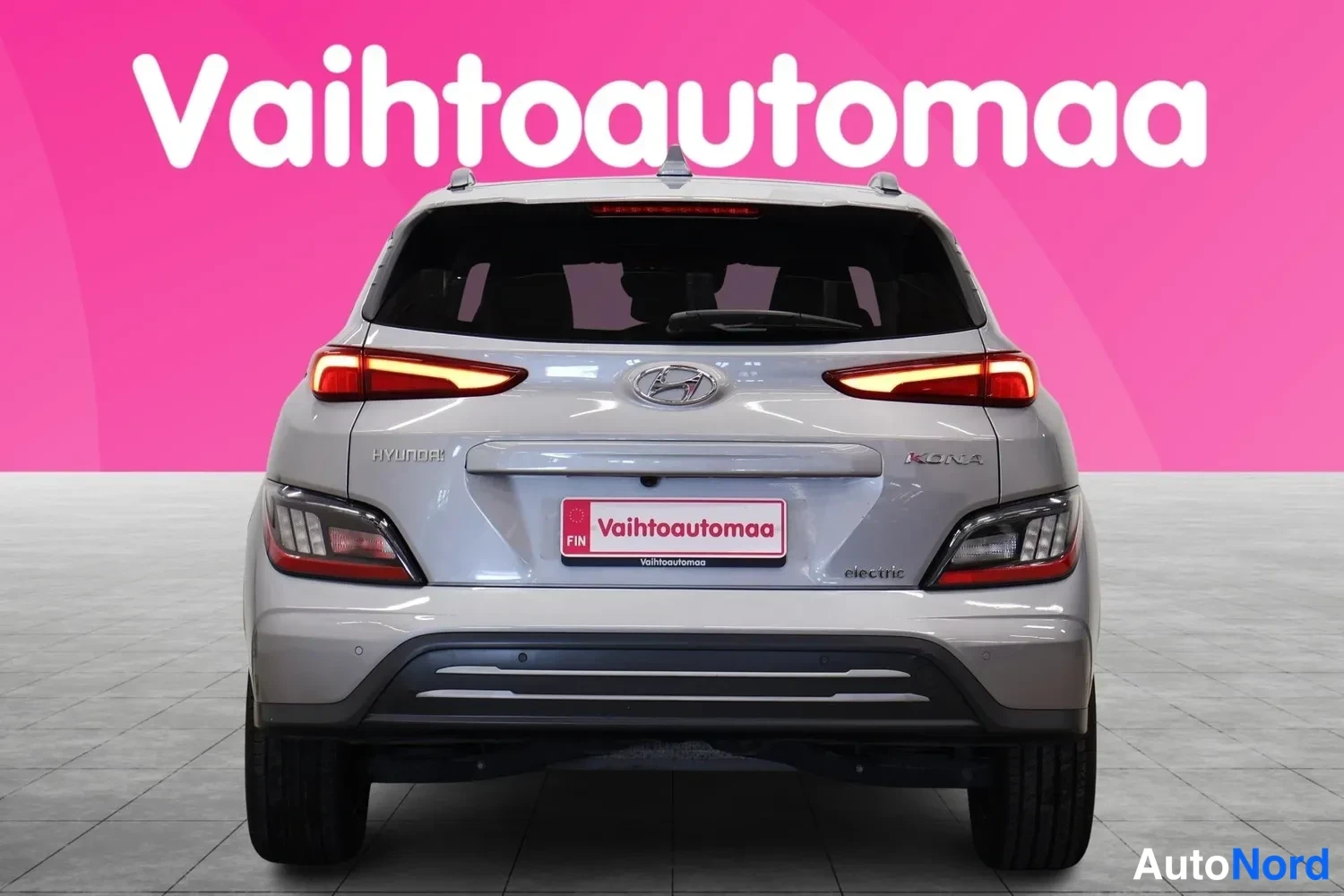 Takaa: Hyundai Kona Electric suoraan takaa, peräovessa Hyundai- ja Kona-merkinnät sekä electric-tunnus.