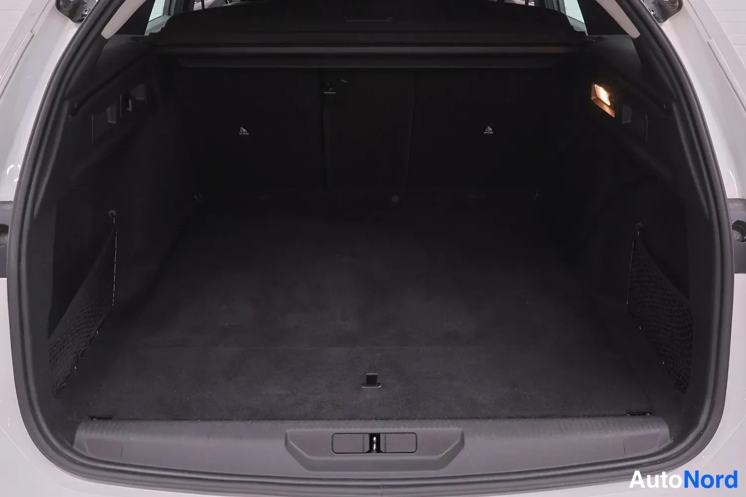 Muu: Peugeot 308:n avattu takaluukki, tyhjä tummatila.