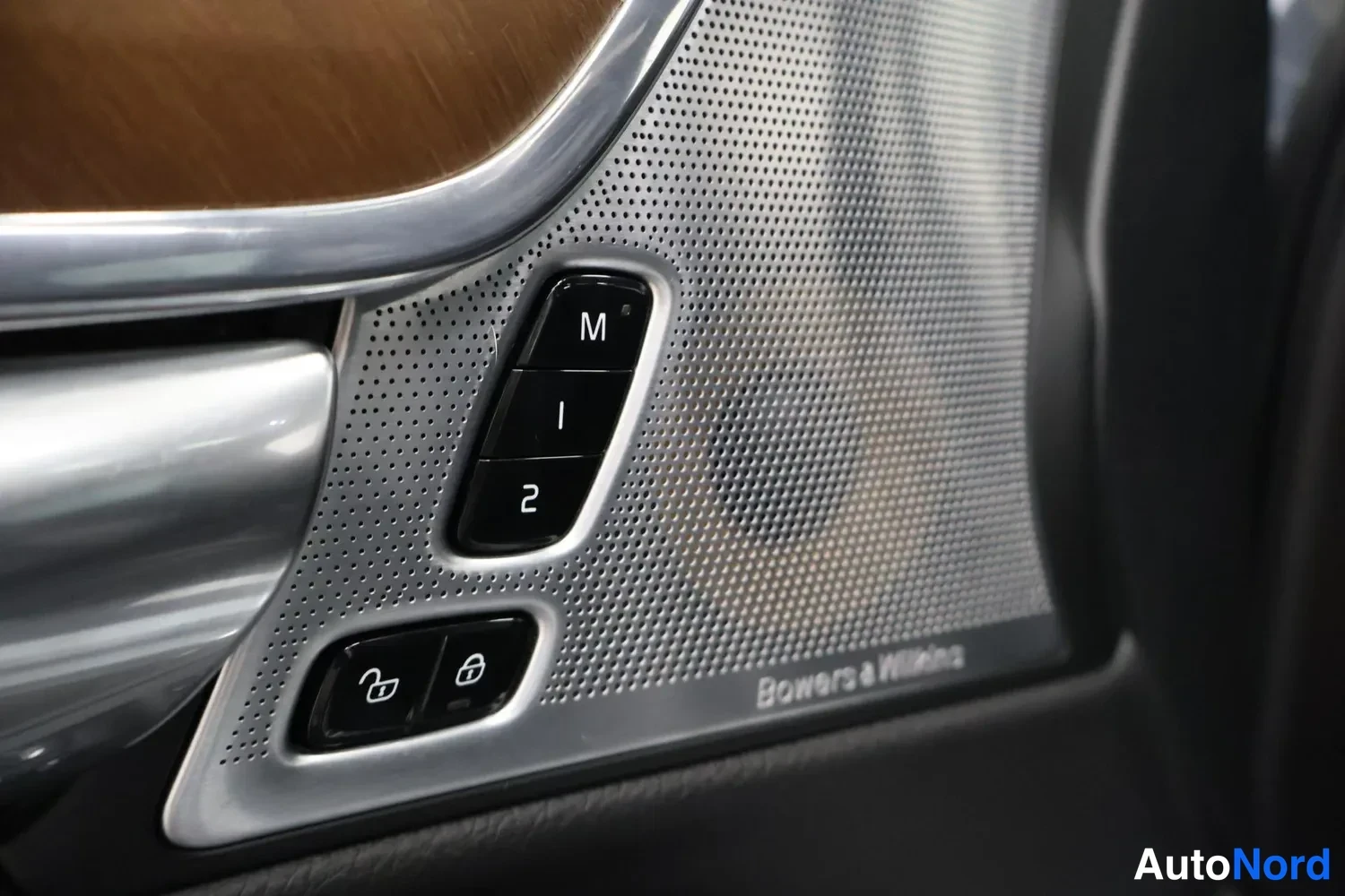Muu: Oven sisäpaneelin Bowers & Wilkins -kaiuttimen verkko ja muistinapit M, 1 ja 2 lähikuvana.