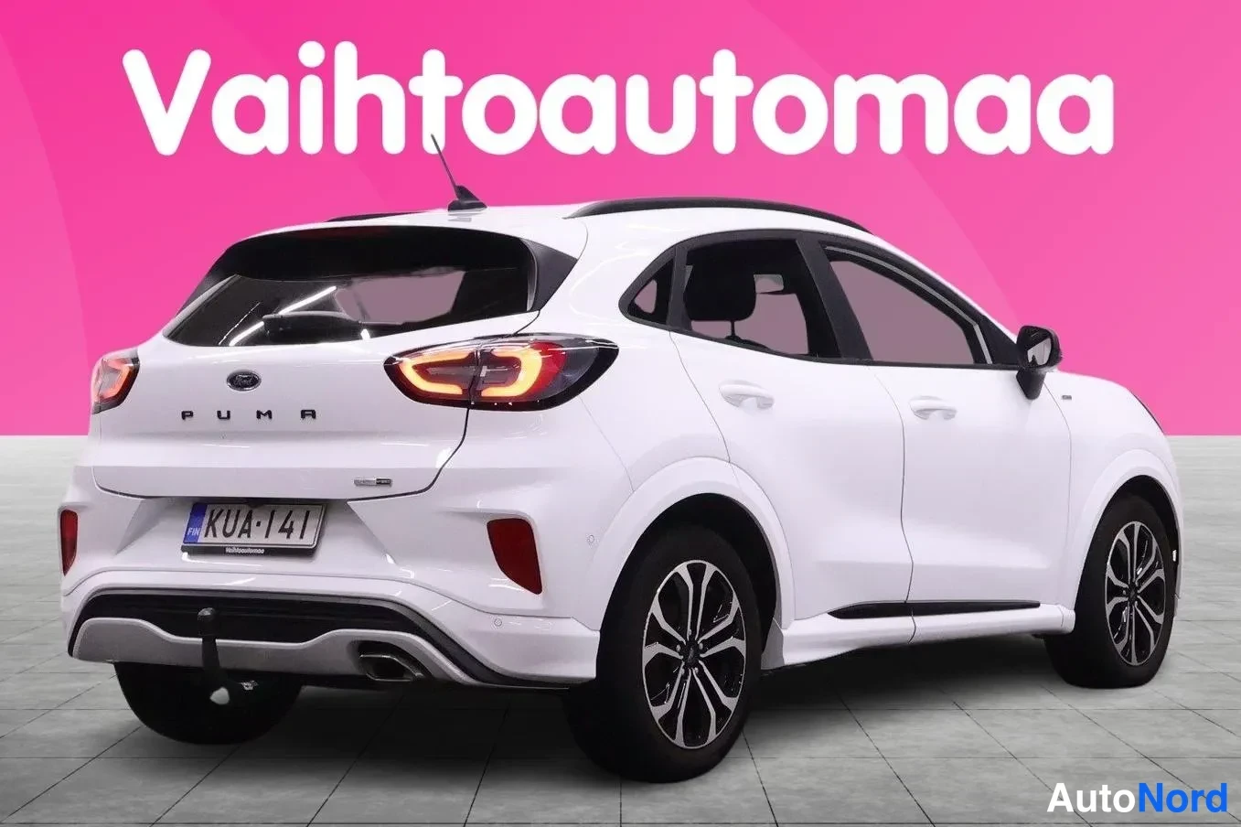 Takaviisto: Ford Puma, valkoinen farmariauton takakulma näkyvissä takavalot, rekisterikilpi ja takana PUMA-teksti