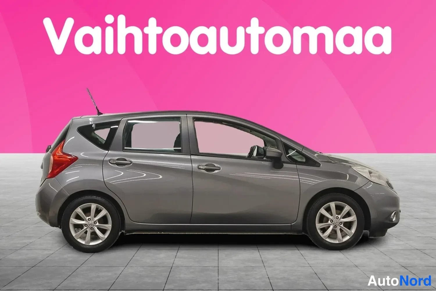 Sivulta: Nissan Note -automobiili sivulta valokuvattuna, harmaan korin oikea sivu ja kevytmetallivanteet näkyvissä.