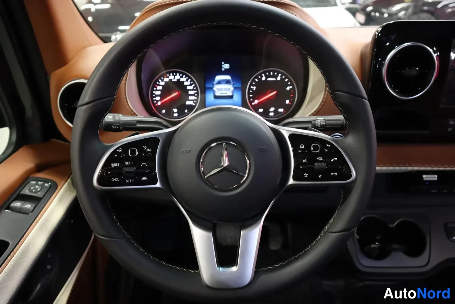 Muu: Mercedes-Benz-ohjauspyörä ja mittaristo: kaksi analogista kierrosmittaria ja keskinäytössä auton kuva, ruskea nahkainen sisusta.