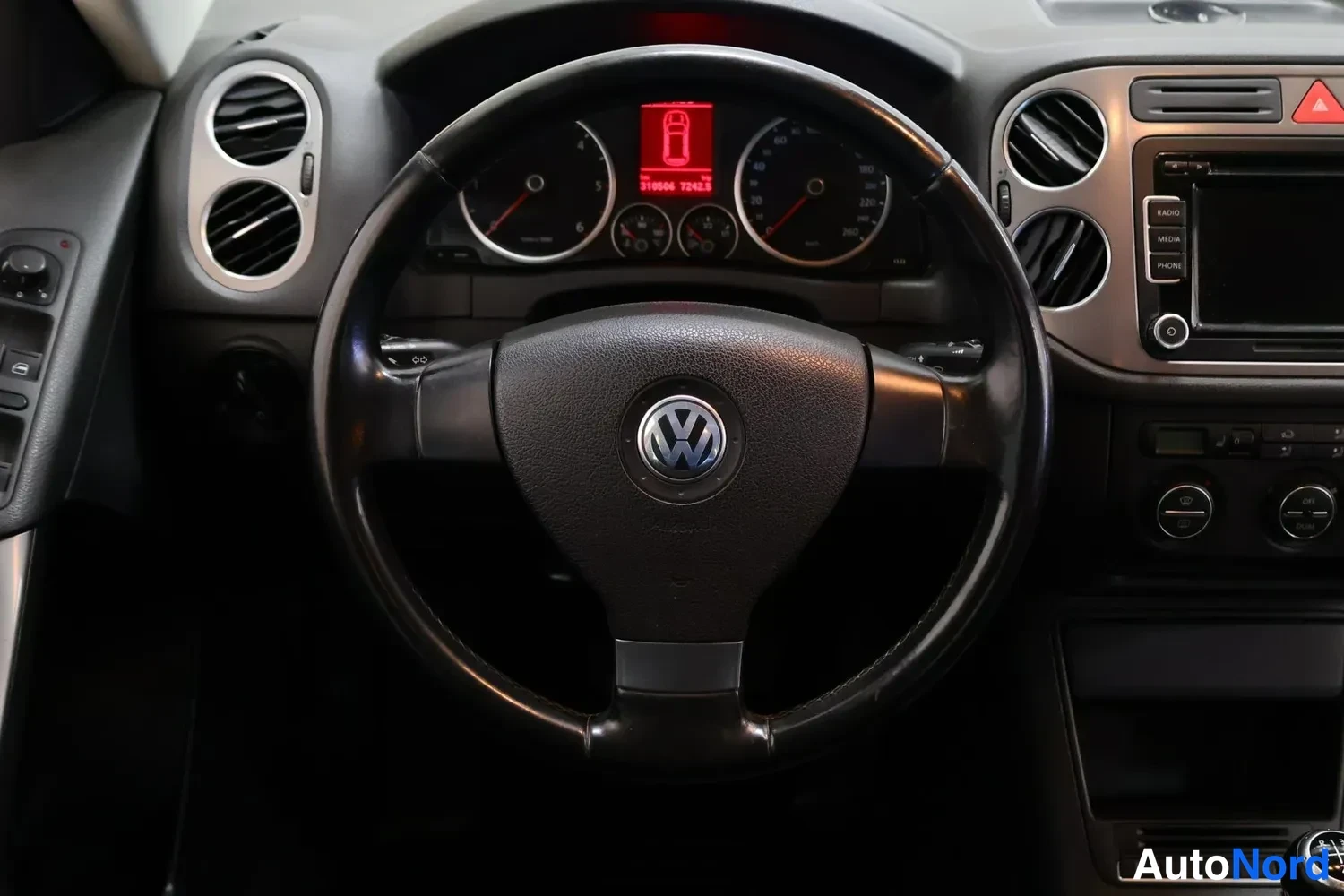 Edestä: VW-ohjauspyörä ja mittaristo, keskikonsolin radio ja ilmastointinapit.