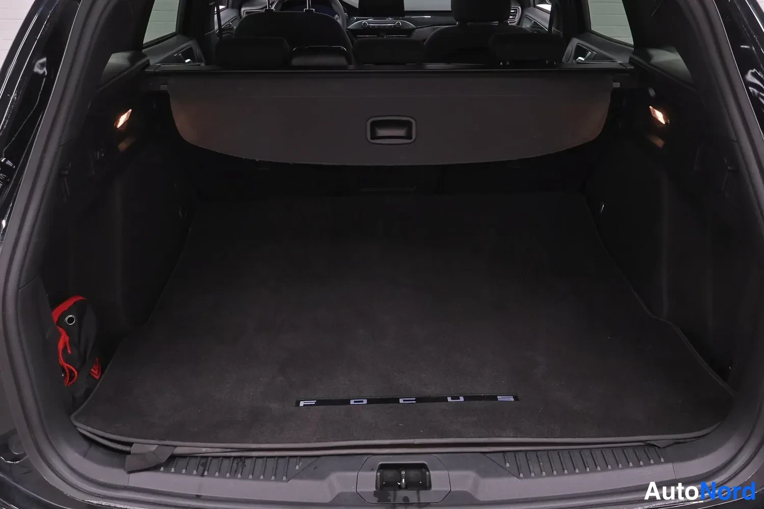 Muu: Ford Focusin avattu tavaratila, tumma matto ja säädettävä tavaratilan suojaverho.