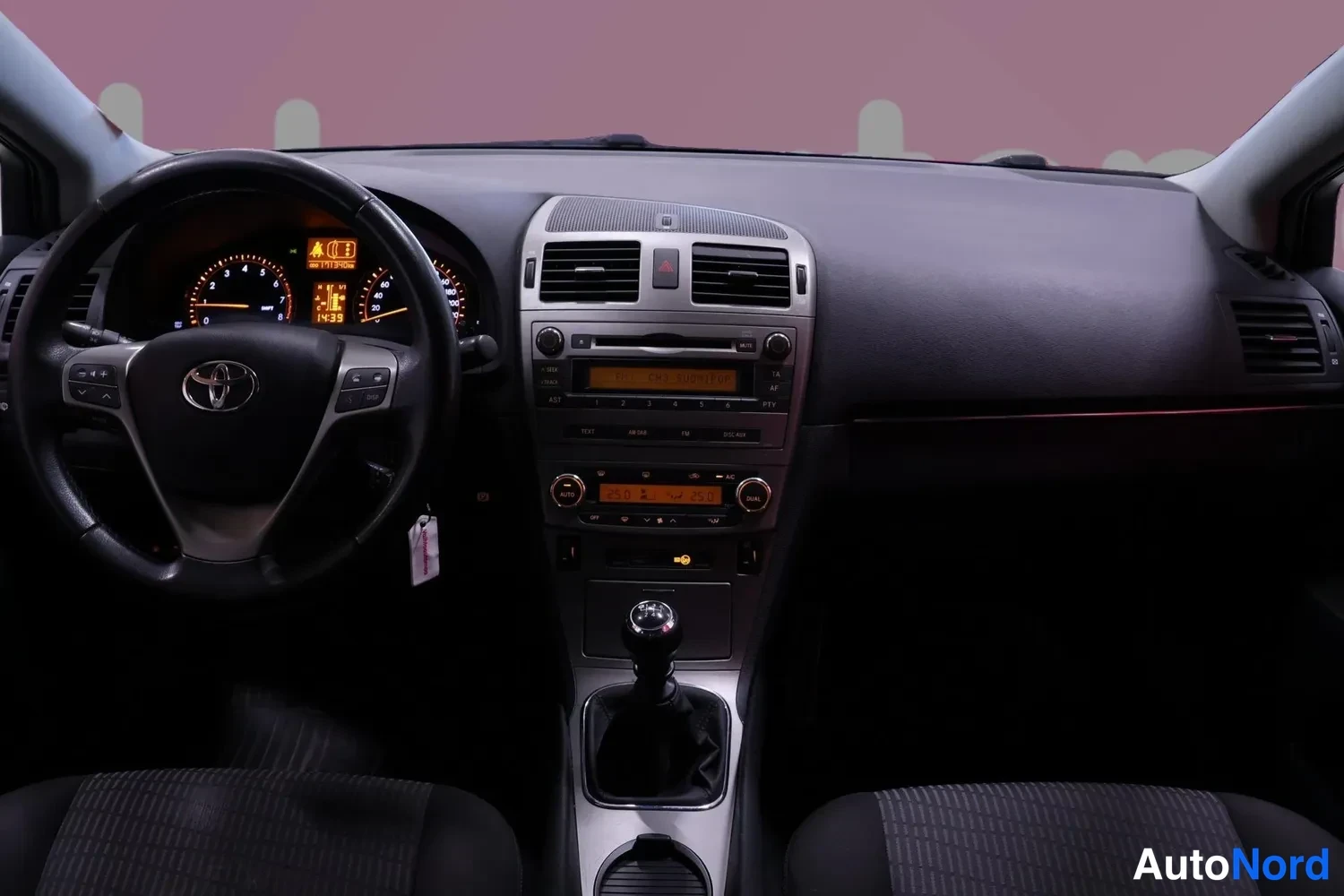 Muu: Kojelauta suoraan edestä: Toyota-ohjauspyörä, mittaristo näyttää 1439 km, keskiyksikön näyttö ja manuaalivaihteiston vipu keskikonsolissa.