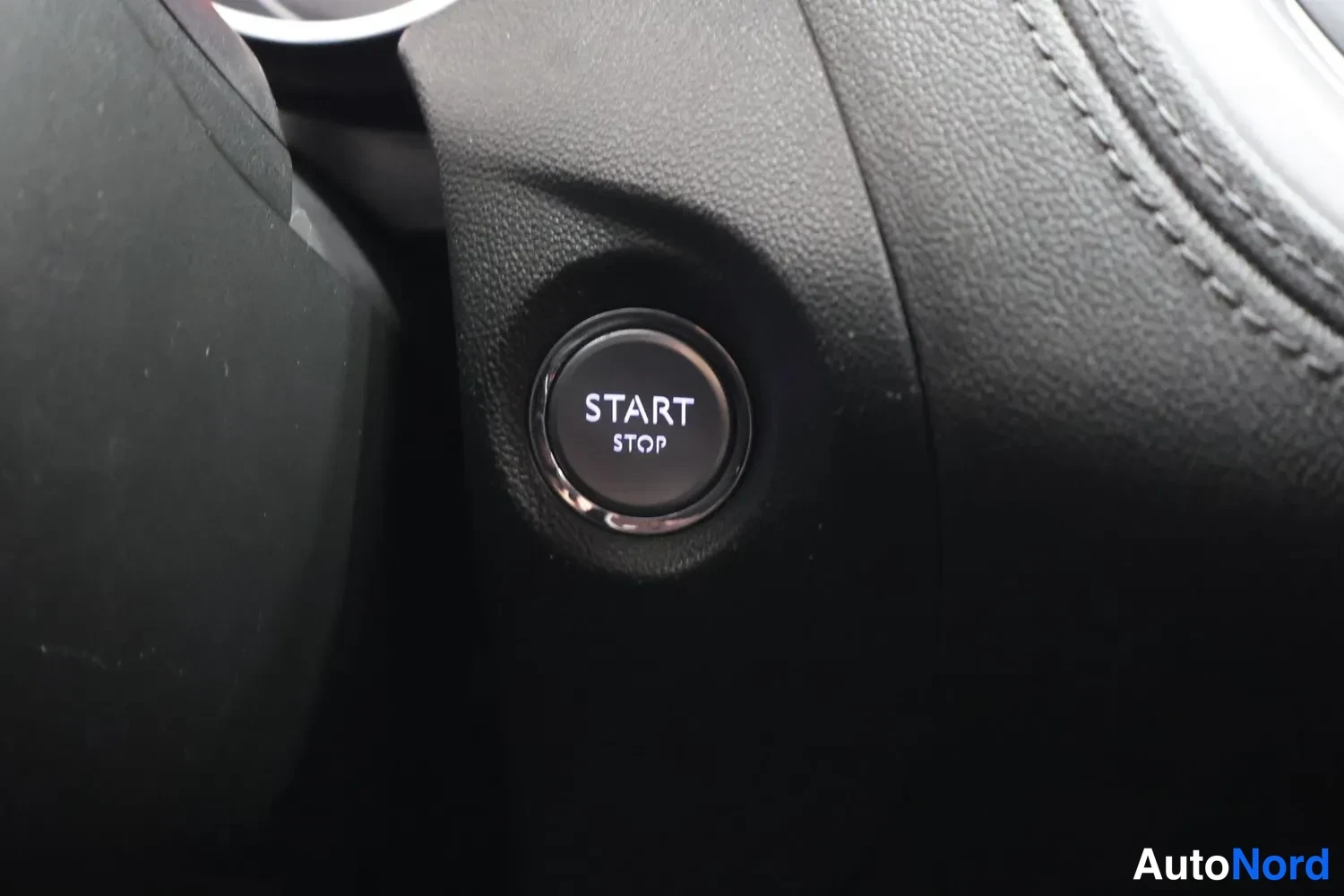 Muu: Start/stop-napit tekstillä 'START STOP' ohjaustangon lähellä, musta muovipinta lähikuvassa.