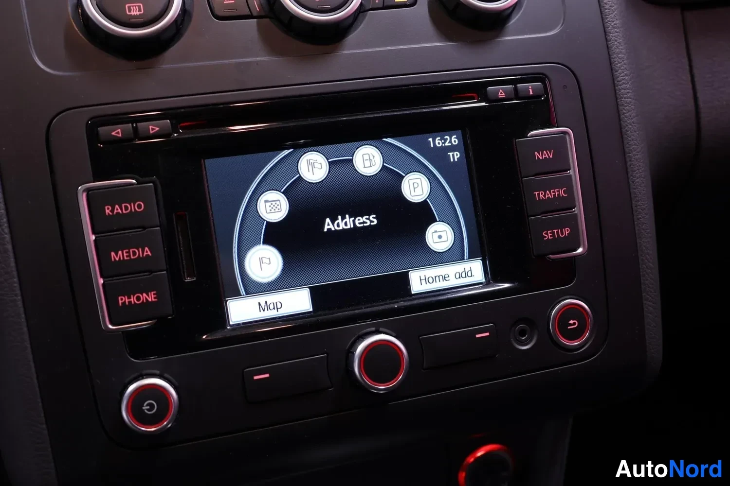 Muu: Kojelaudan navigointipaneeli, näytöllä Address-valikko kello 16:26, painikkeina Map ja Home add sekä NAV, TRAFFIC ja SETUP.