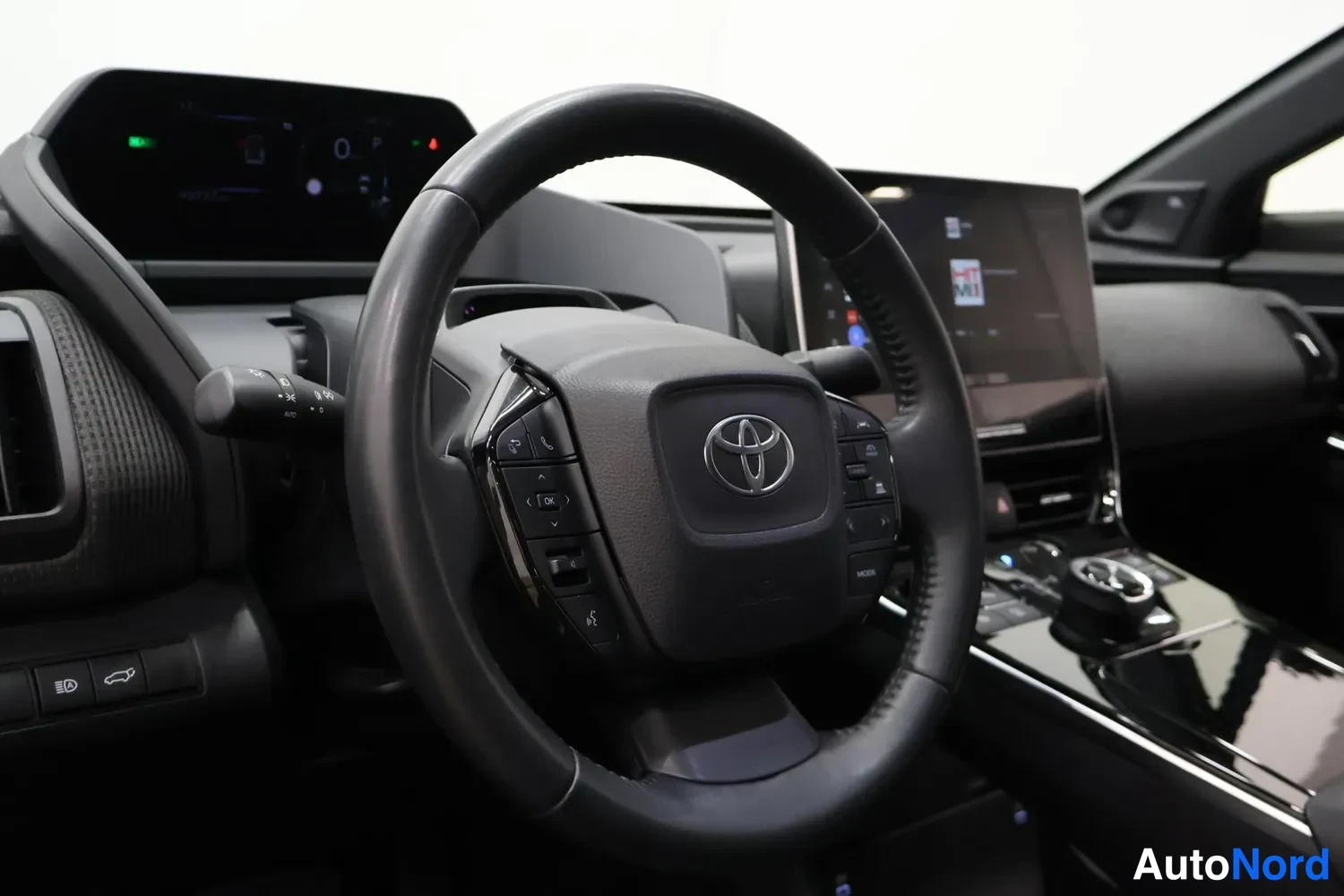 Muu: Toyota-merkkinen ohjauspyörä, kojelauta ja infotainmentnäyttö studiovalossa.