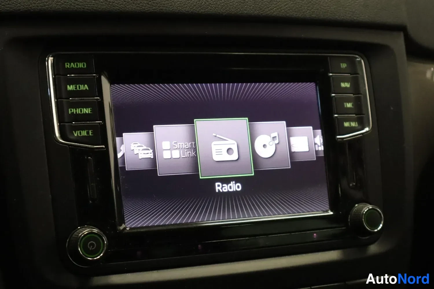 Muu: Infotainment-järjestelmän päävalikko korostuneella Radio-kuvakkeella, vieressä Smart Link -kuvake.