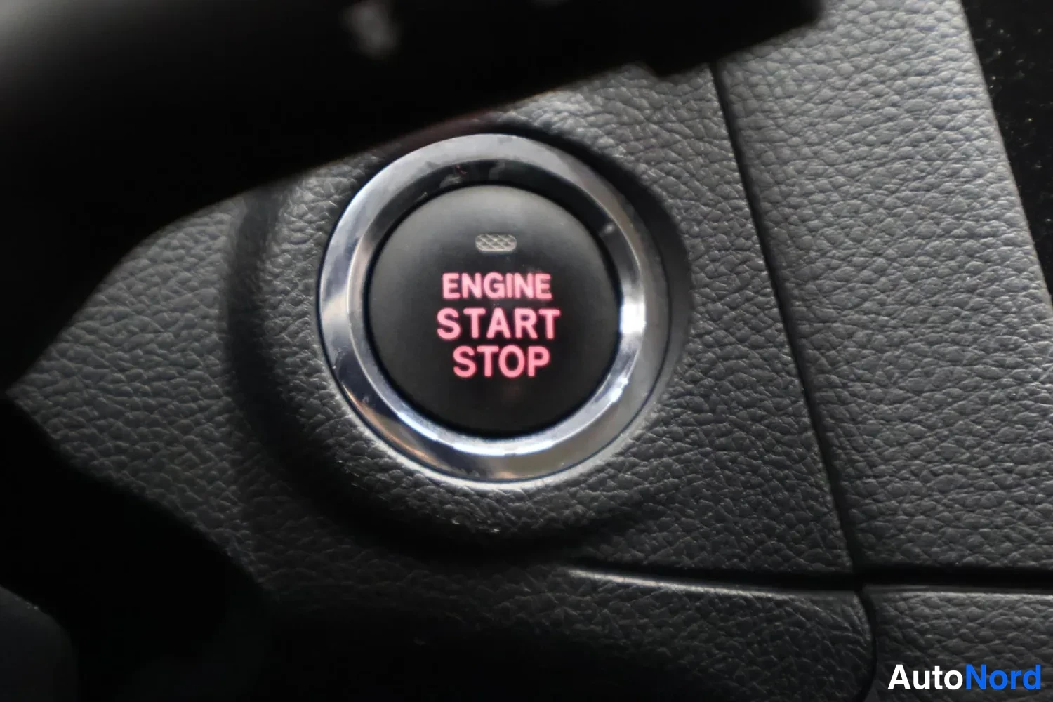 Muu: Punainen ENGINE START STOP -käynnistyspainike, teksti lukee 'ENGINE START STOP'.