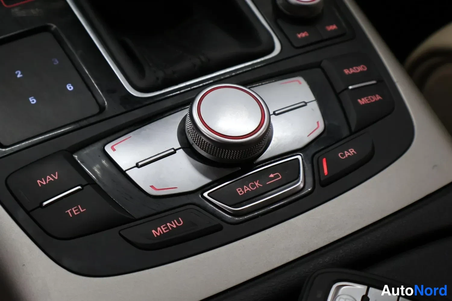 Muu: Sisätilakuvan keskikonsolin valikkopaneeli, jossa MMI-kiertonappi ja painikkeet NAV, TEL, MENU, BACK, CAR, RADIO ja MEDIA.