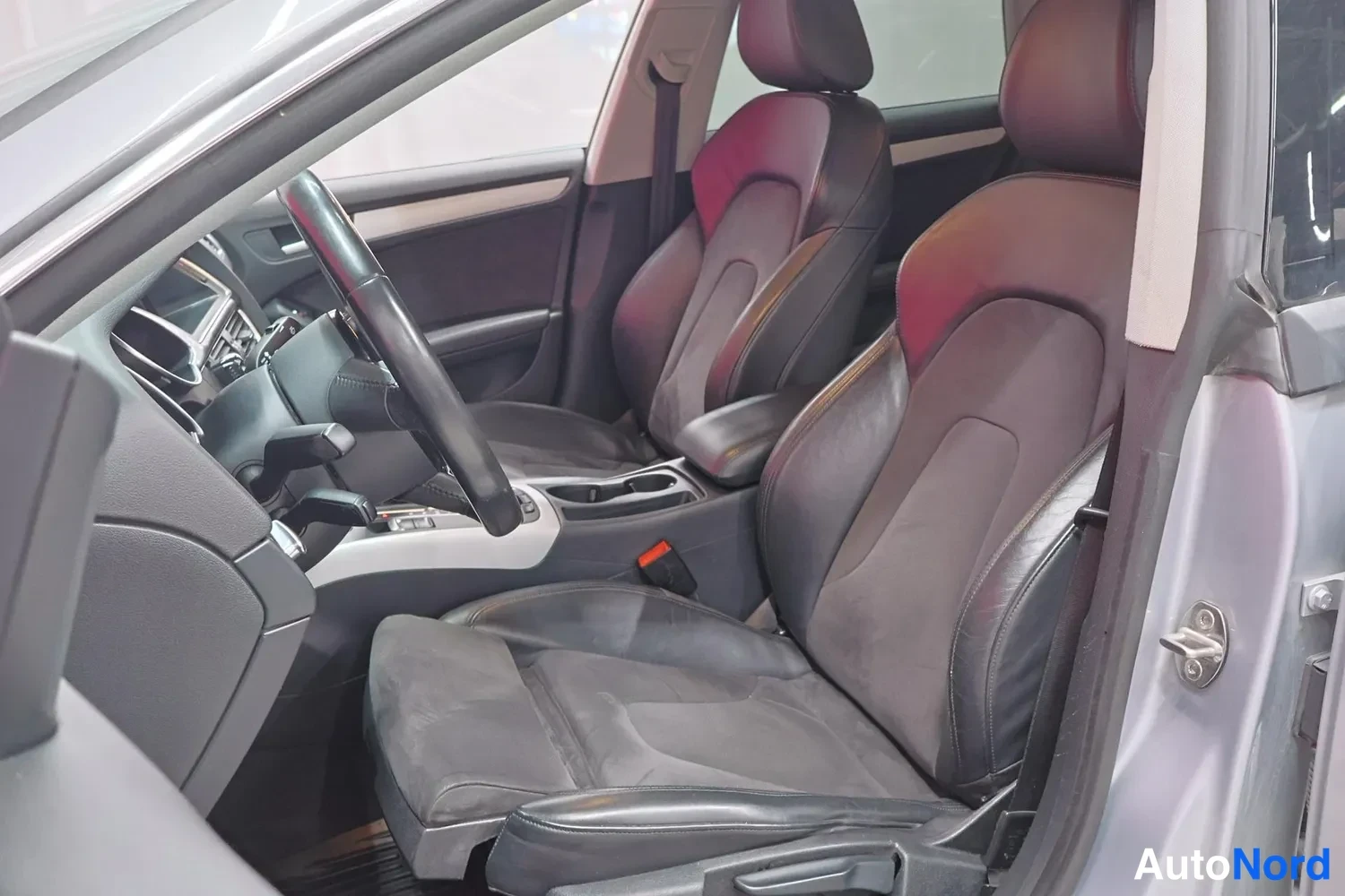Edestä: Audi A5 Sportbackin etusisätilat kuljettajan ja etumatkustajan istuimineen, ohjauspyörä ja keskikonsoli.
