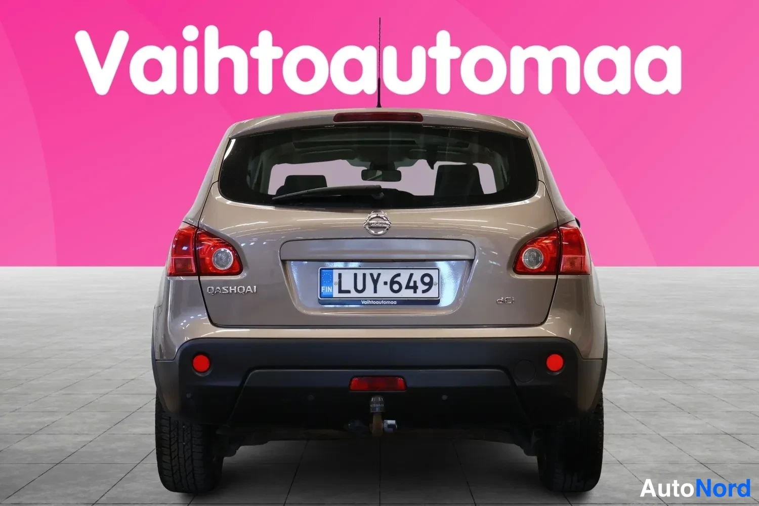 Takaa: Nissan Qashqai takaapäin, rekisteri, vaaleanbeige; perä ja takavalot näkyvissä.