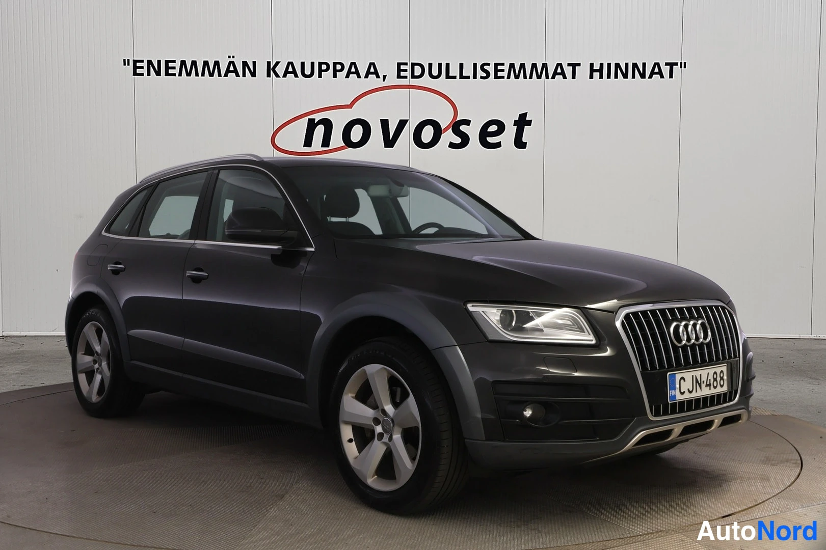 Etuviisto, nokka oikealle: Tummanharmaa Audi Q5 kulmassa kuvattuna edestä oikealta, rekisteritunnus.