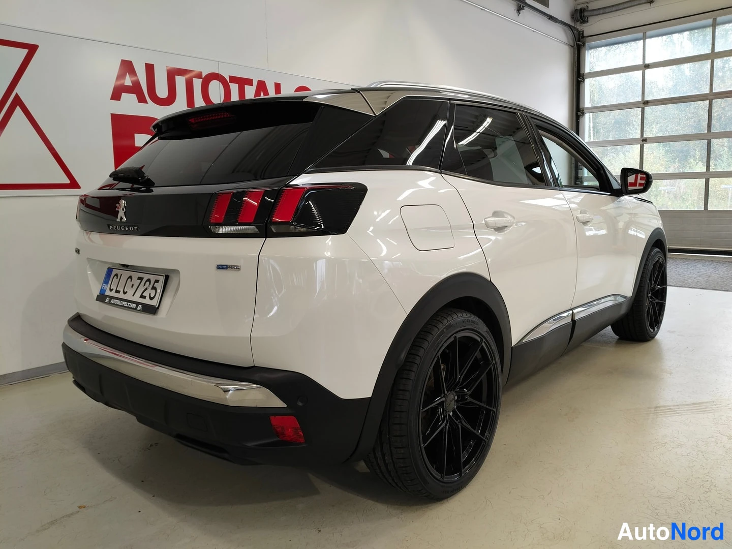 Takaviisto: Taka-kulmanäkymä valkoisesta Peugeot 3008:sta vasemmalta takaa, mustat takavalot, mustat kevytmetallivanteet ja rekisteritunnus näkyvät.