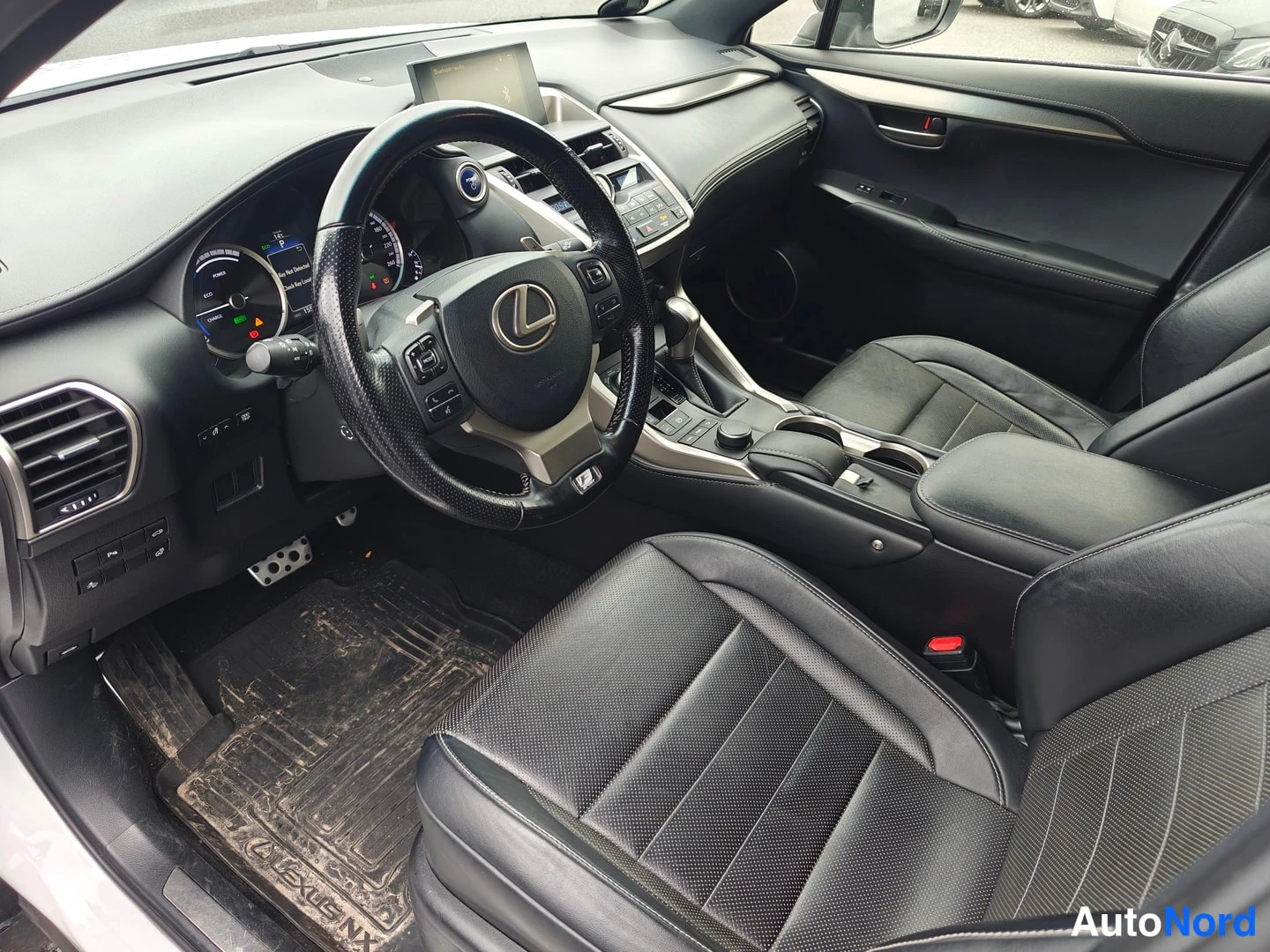 Muu: Lexus NX:n ohjaamo kuvattuna kuljettajan puolelta, nahkaverhoillut istuimet ja multipöytä.
