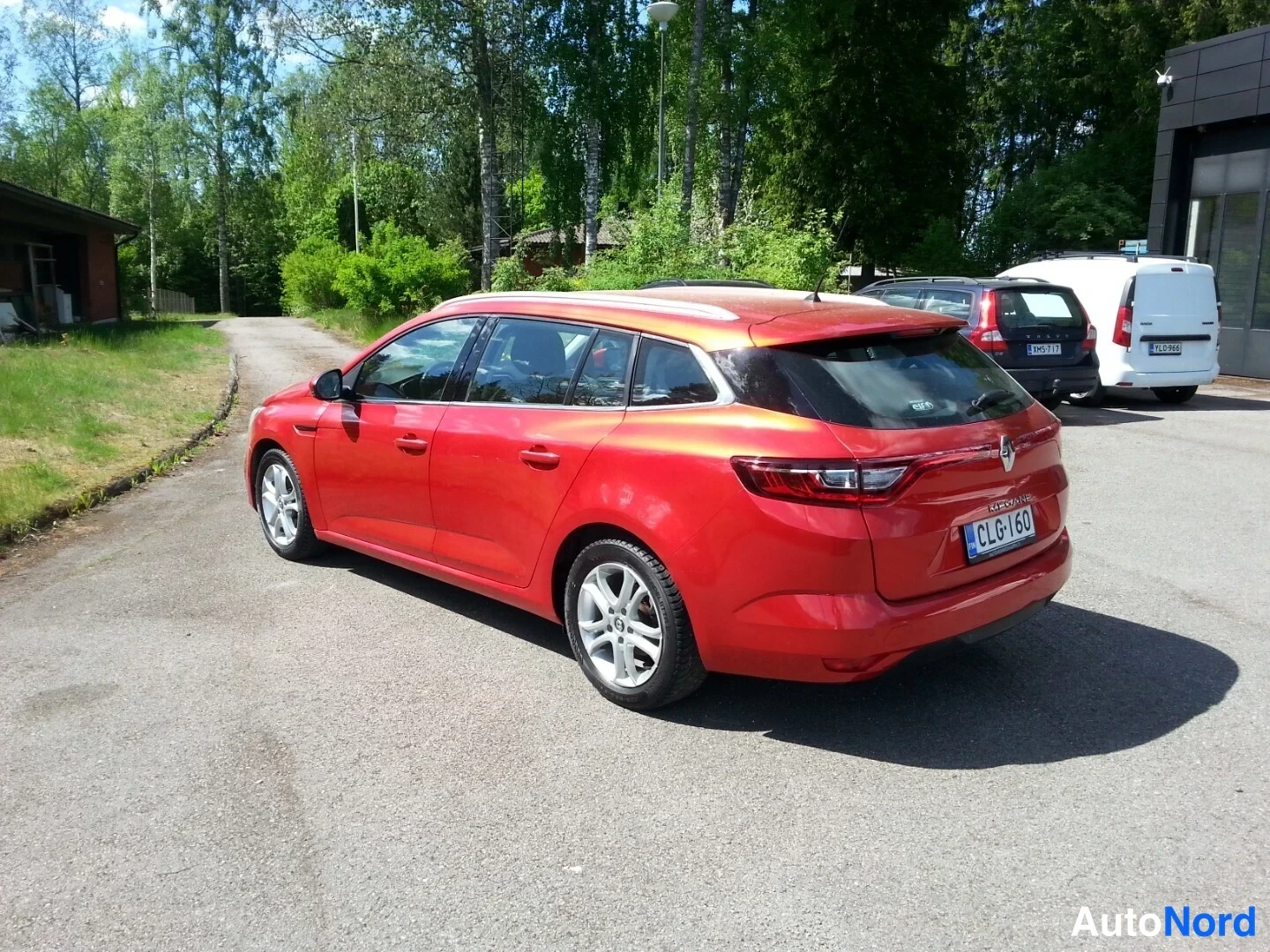 Takaviisto: Punaisen Renault Megane Sport Tourer -farmarin takaosa ja vasen kylki kolmanneskulmasta takaa.