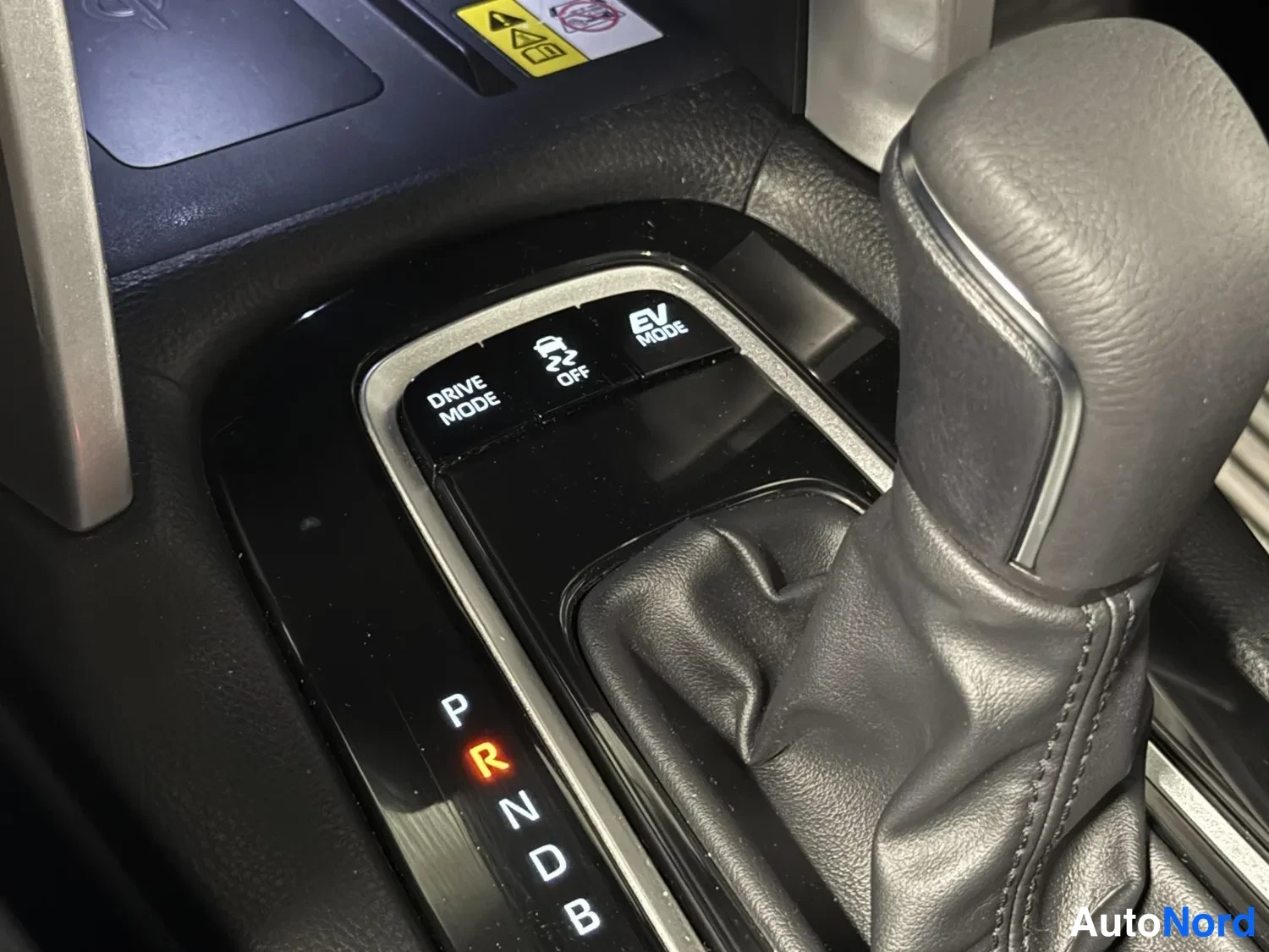 Muu: Automaattivaihteen valitsin P R N D B -asemilla, R valaistuna, sekä DRIVE MODE, vetoluiston OFF- ja EV MODE -painikkeet.