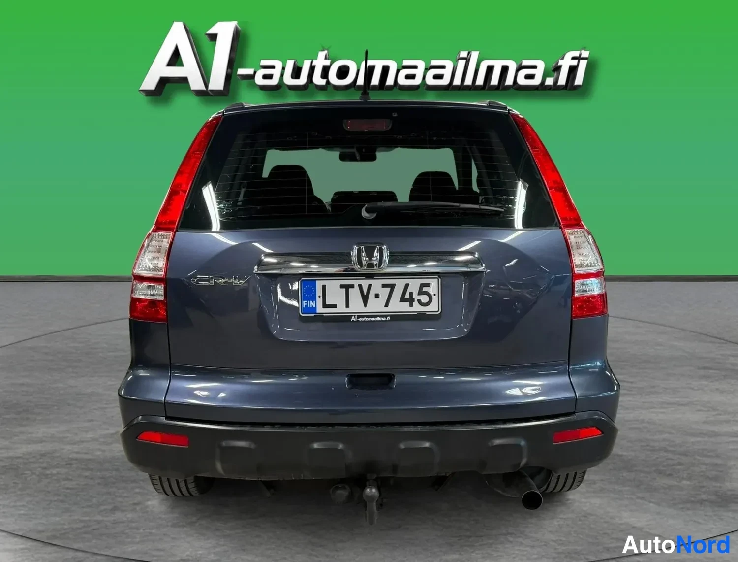 Takaa: Honda CR-V:n takanäky; tummansininen koristi, rekisterikilpi, lukkiutumattomat jarrut, valaisimet ja vetokoukun pallo näkyvät.