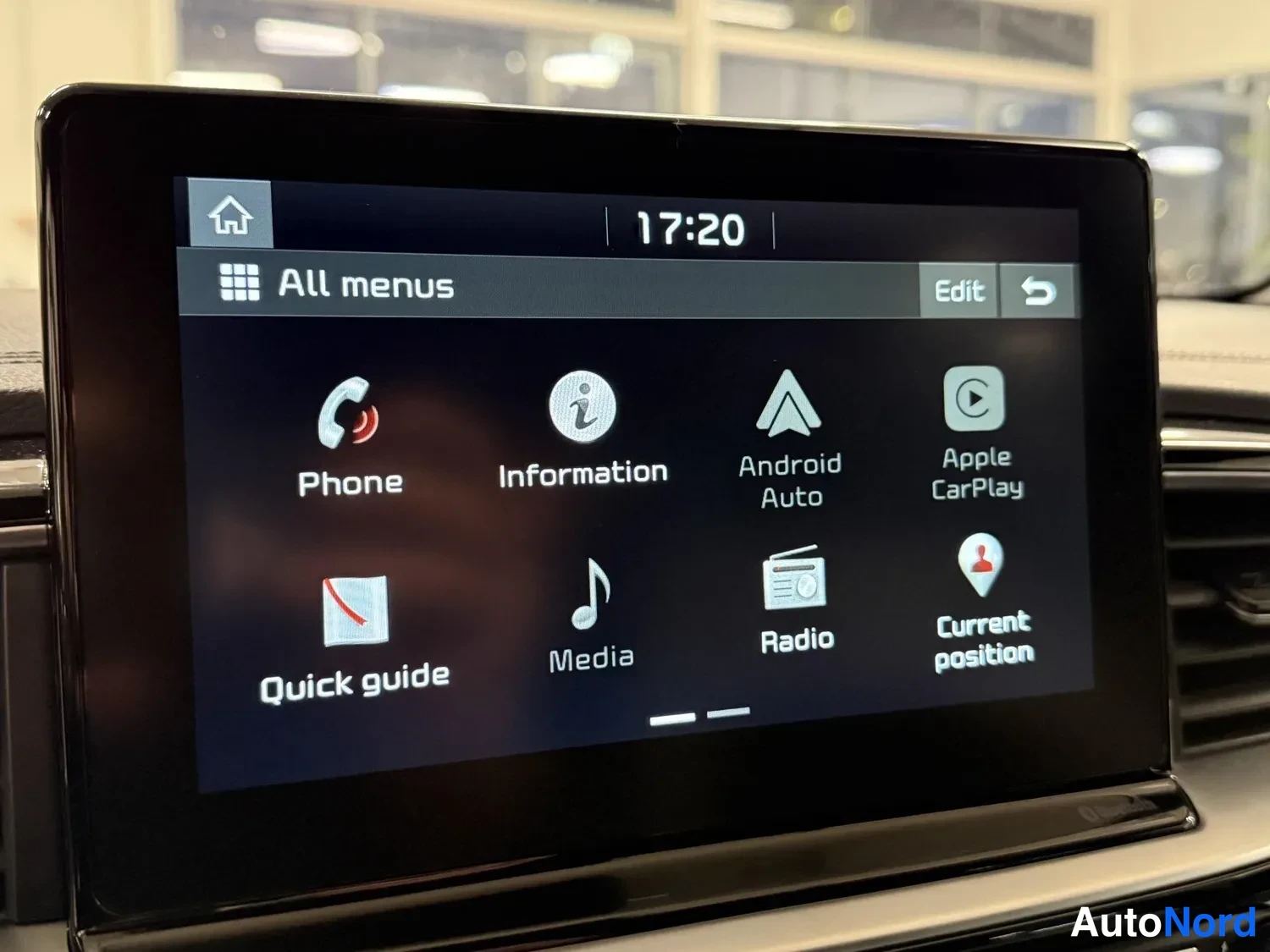 Yksityiskohta: Auton keskinäytön valikko näkyy kuvassa: Phone, Information, Android Auto, Apple CarPlay, Quick guide, Media, Radio ja Current position, kello 17:20.