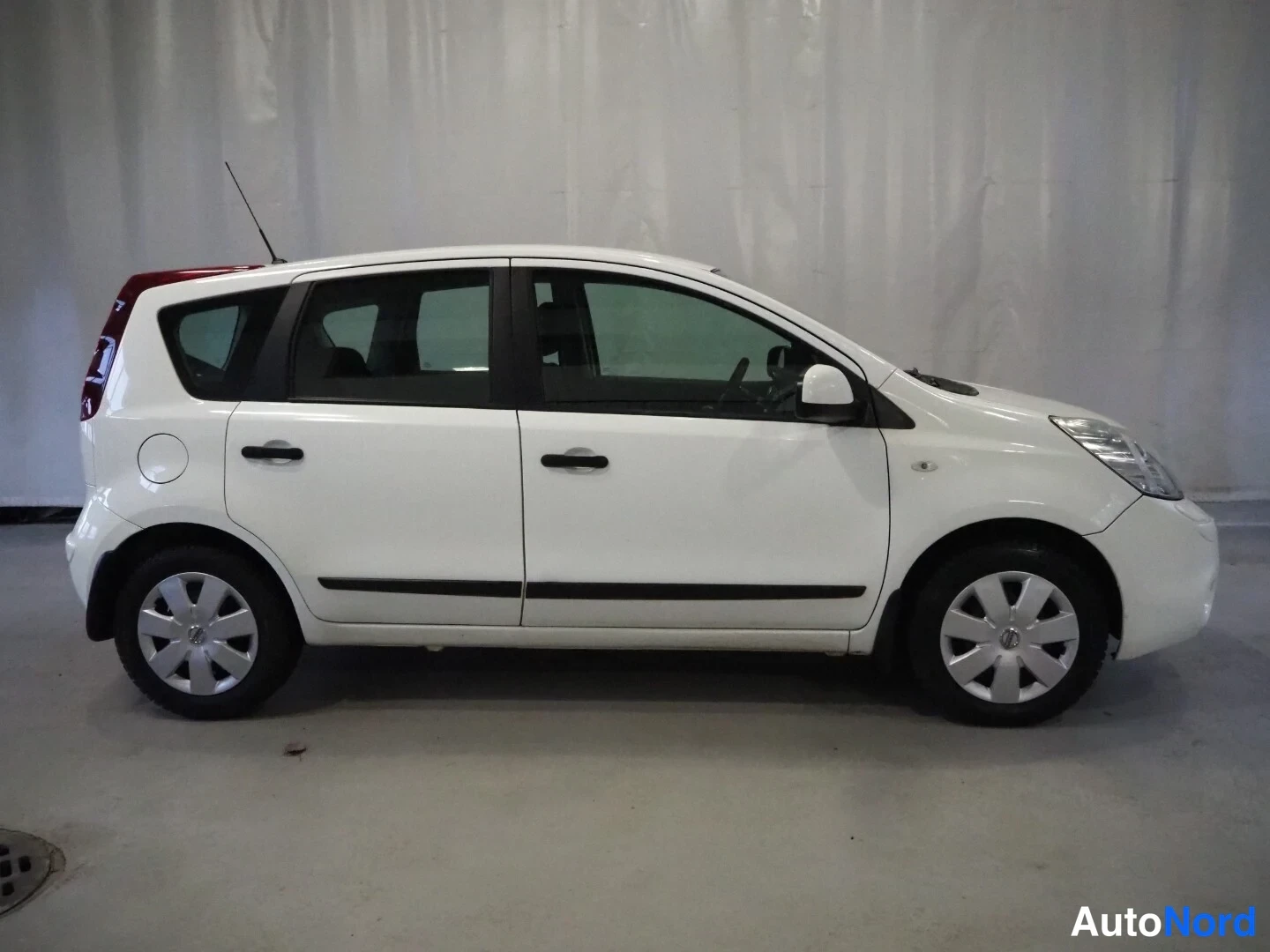 Sivulta: Valkoisen Nissan Noten sivuprofiili, keulaoikealle.