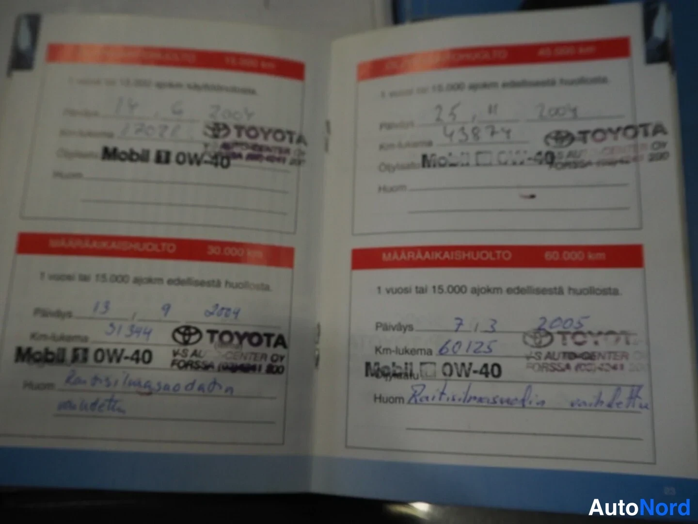 Asiakirja: A page from a Toyota service book showing four maintenance records. The handwritten entries include service dates in the format day/month/year (e.g., 14.6.2004,