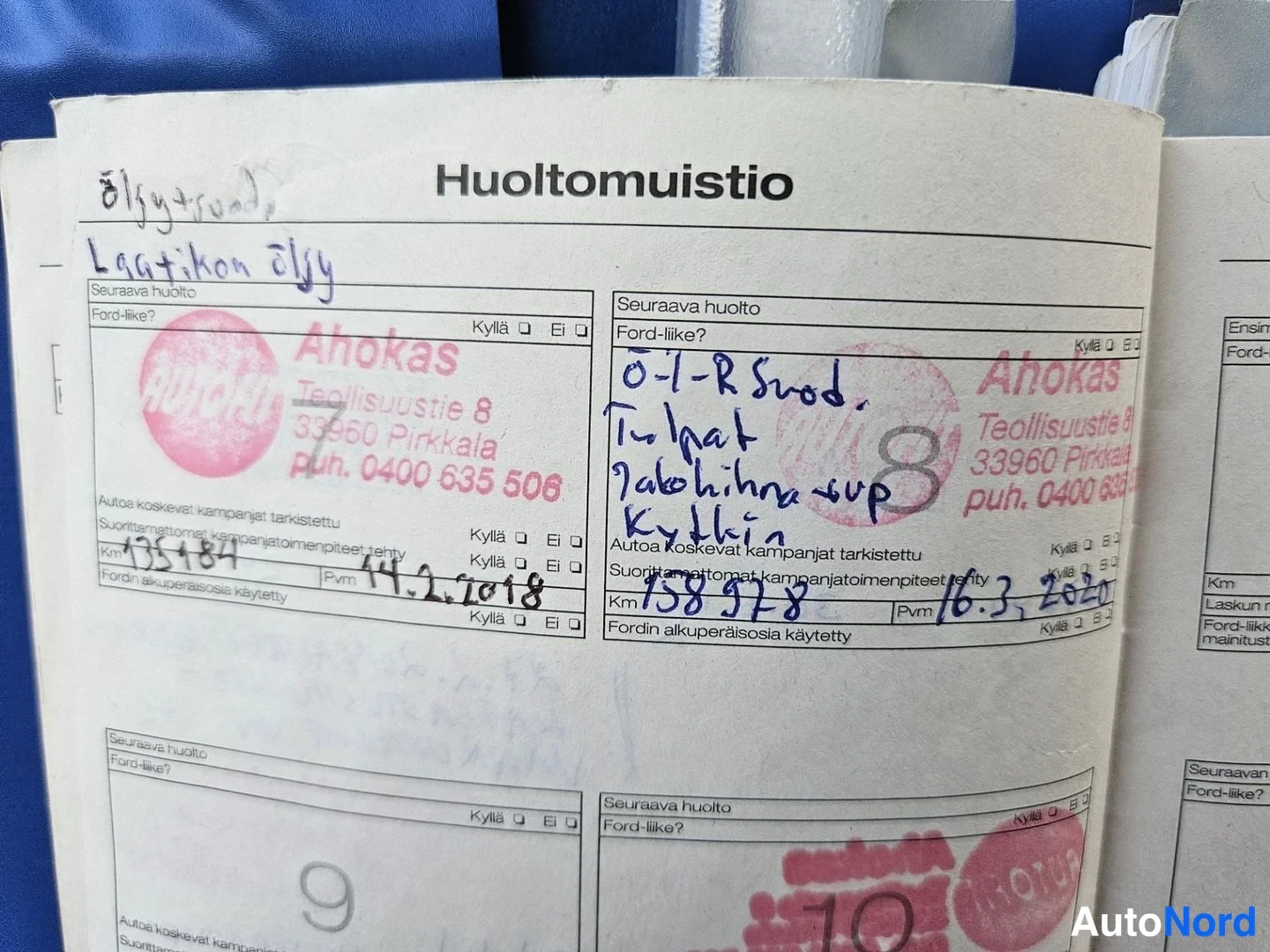 Muu: Huoltomuistio-vihkon avattu sivu, jossa käsinkirjoitettuja huolto-merkintöjä ja Ahokas-leimoja vuosilta 2018 ja 2020.