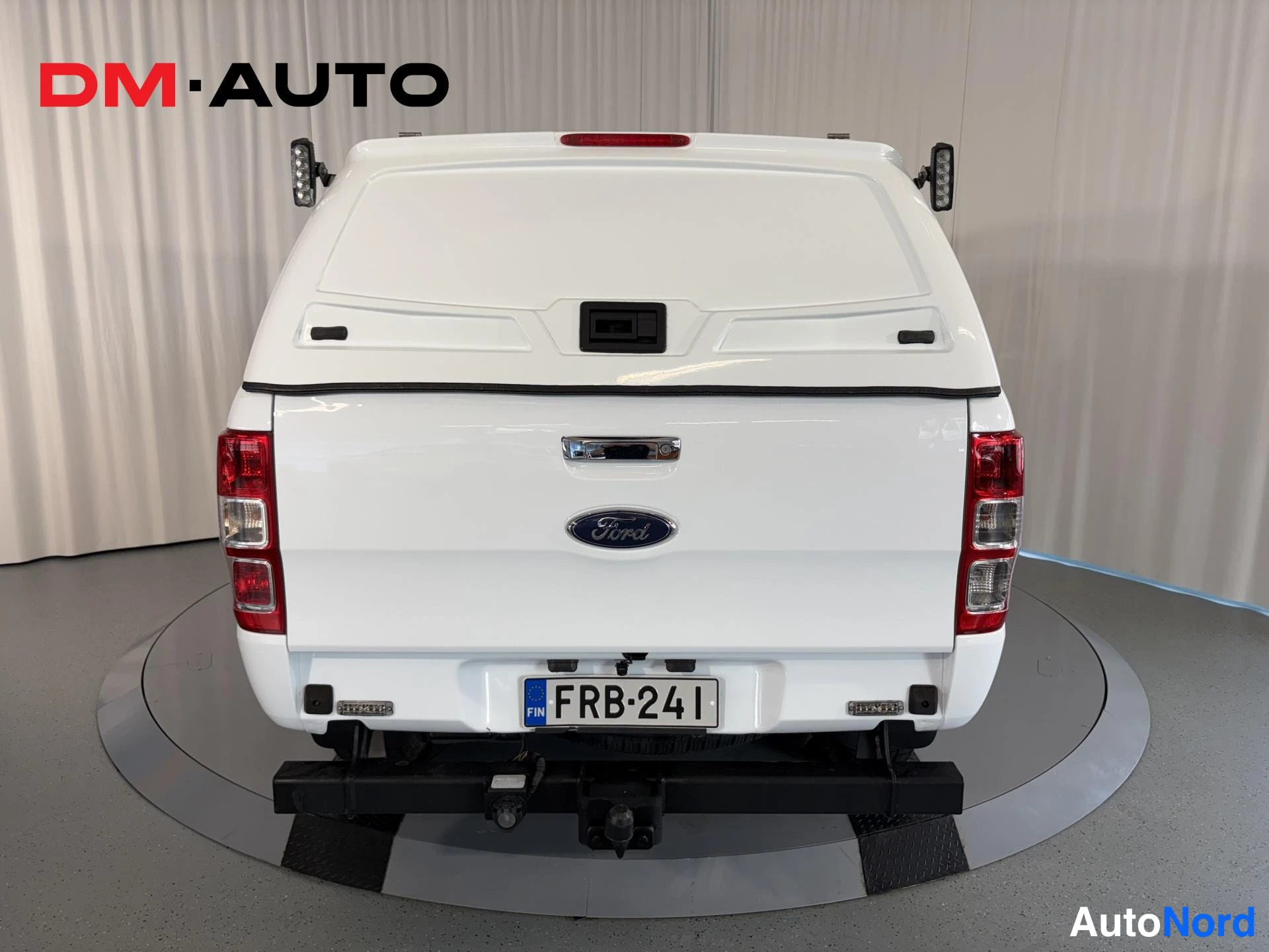 Takaa: Ford Ranger suoraan takaa; valkoinen kori ja peitekansi, Ford-merkki ja rekisteri takaluukussa.