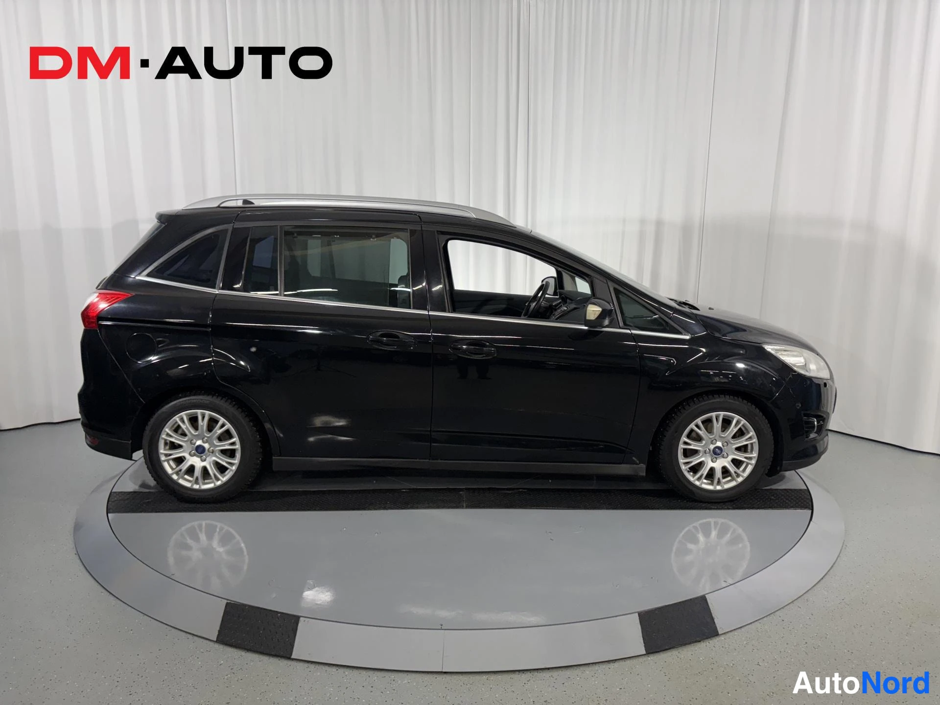 Sivulta: Mustan Ford C-MAX -tilavaunun sivukuva vasemmalta, neljä ovea ja kattokaiteet näkyvissä.