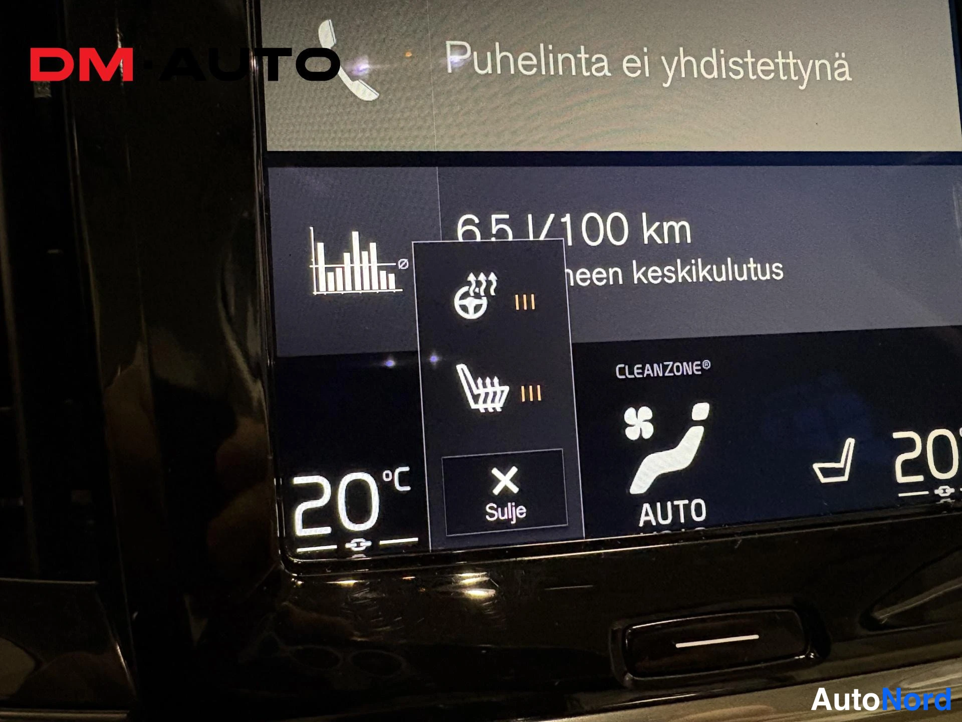 Muu: Tieverotusnäytön lähikuva: puhelintila, keskiluku 6.5 l/100 km, CLEANZONE-merkintä ja sulje-painike.