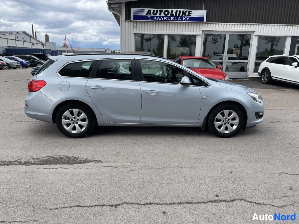 Sivulta: Opel Astra -farmari vasemmalta sivulta kuvattuna, vaaleansininen koripelti.