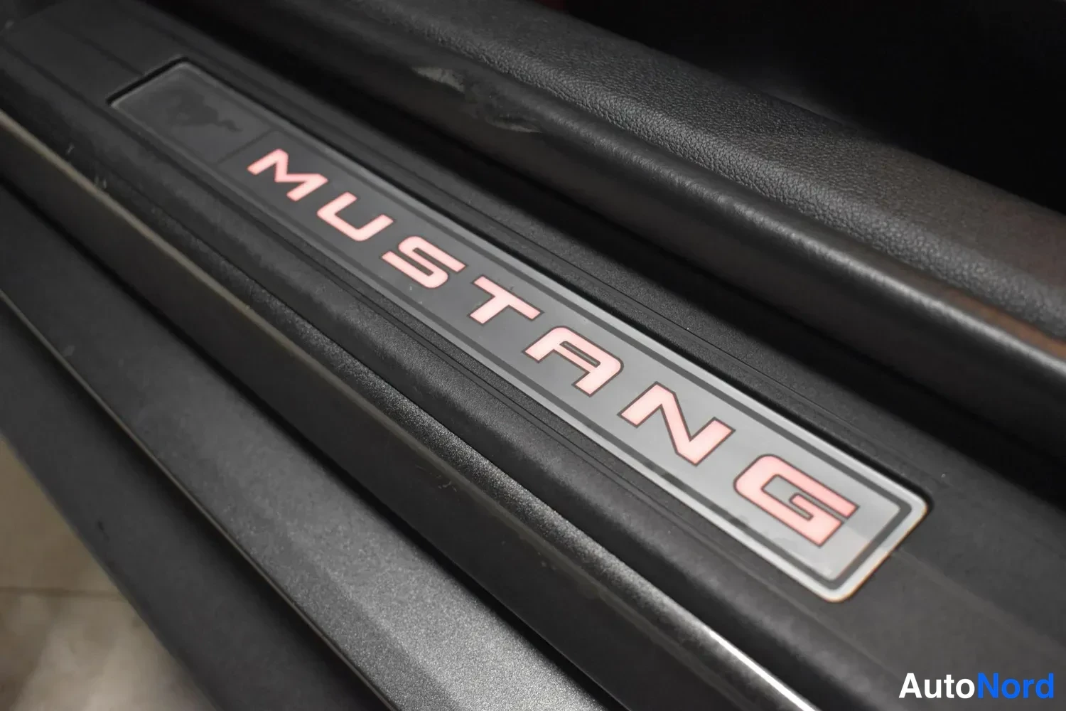 Muu: Oven kynnyslistassa valaistu MUSTANG-teksti