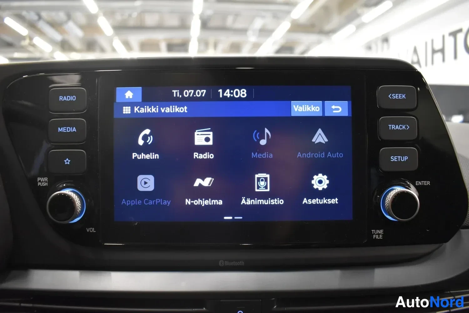 Yksityiskohta: Autoradion ja multimedialaitteen näyttö, jossa on valikko: Puhelin, Radio, Media, Android Auto, Apple CarPlay, N-ohjelma, Äänimuistio ja Asetukset.