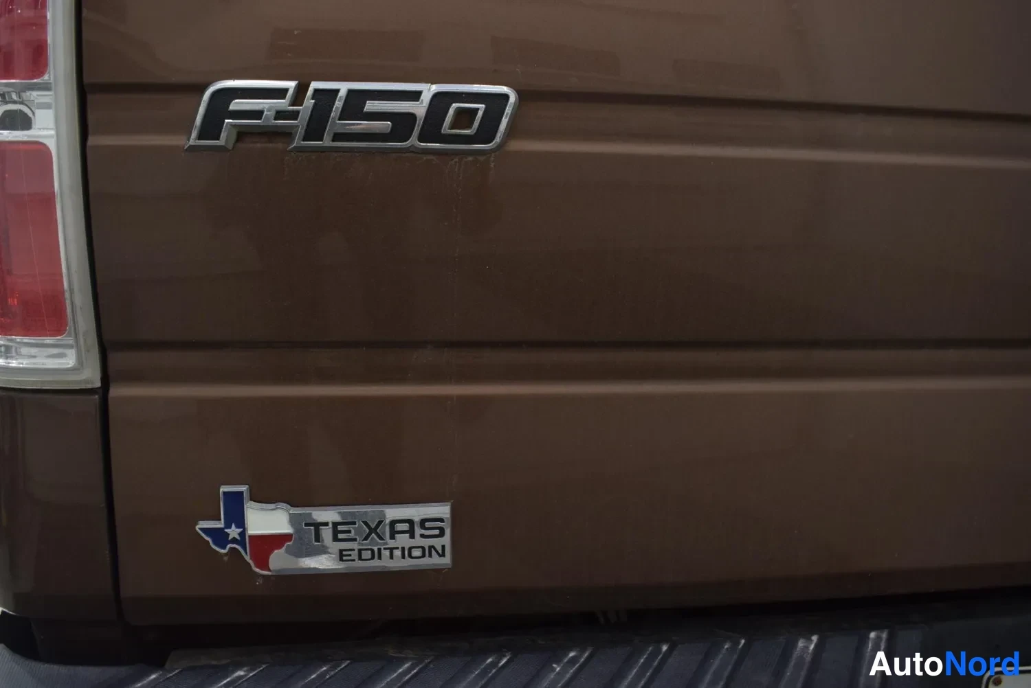 Takaa: Ruskean ajavaoven takapuolen lokero F-150-merkinnällä ja Texas Edition -emblemillä.
