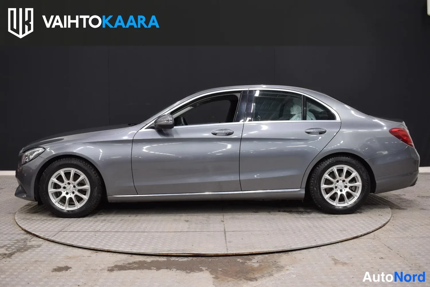 Sivulta: Mercedes-Benz C-sarjan sedan sivusta oikealta, harmaan korin ovet ja Hopeametallivanteet.