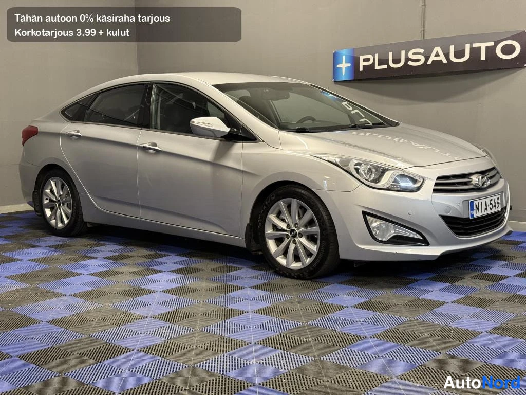 Etuviisto, nokka oikealle: Hyundai i40 -sedanin etukolmasivunäkymä, hopeinen korilainen sisätiloissa.