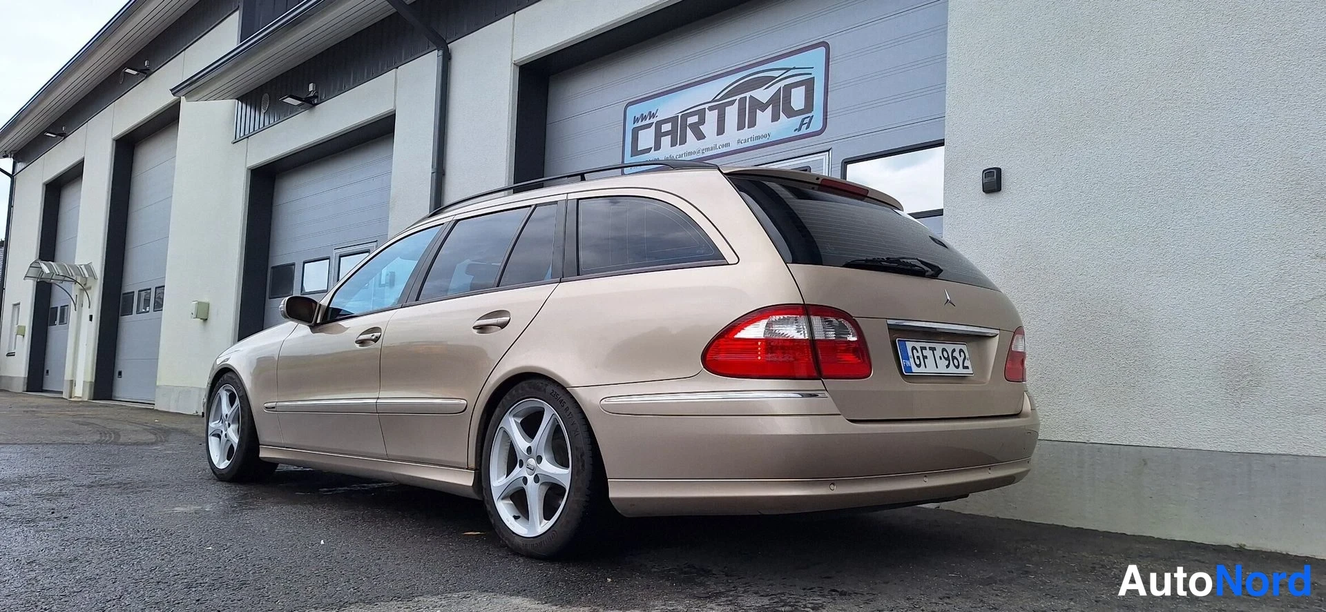 Takaviisto: Mercedes-Benz E-farmarimallin takaosan kolmasosan kuva, beige vaaleanruskea auto, rekisterikilpi.
