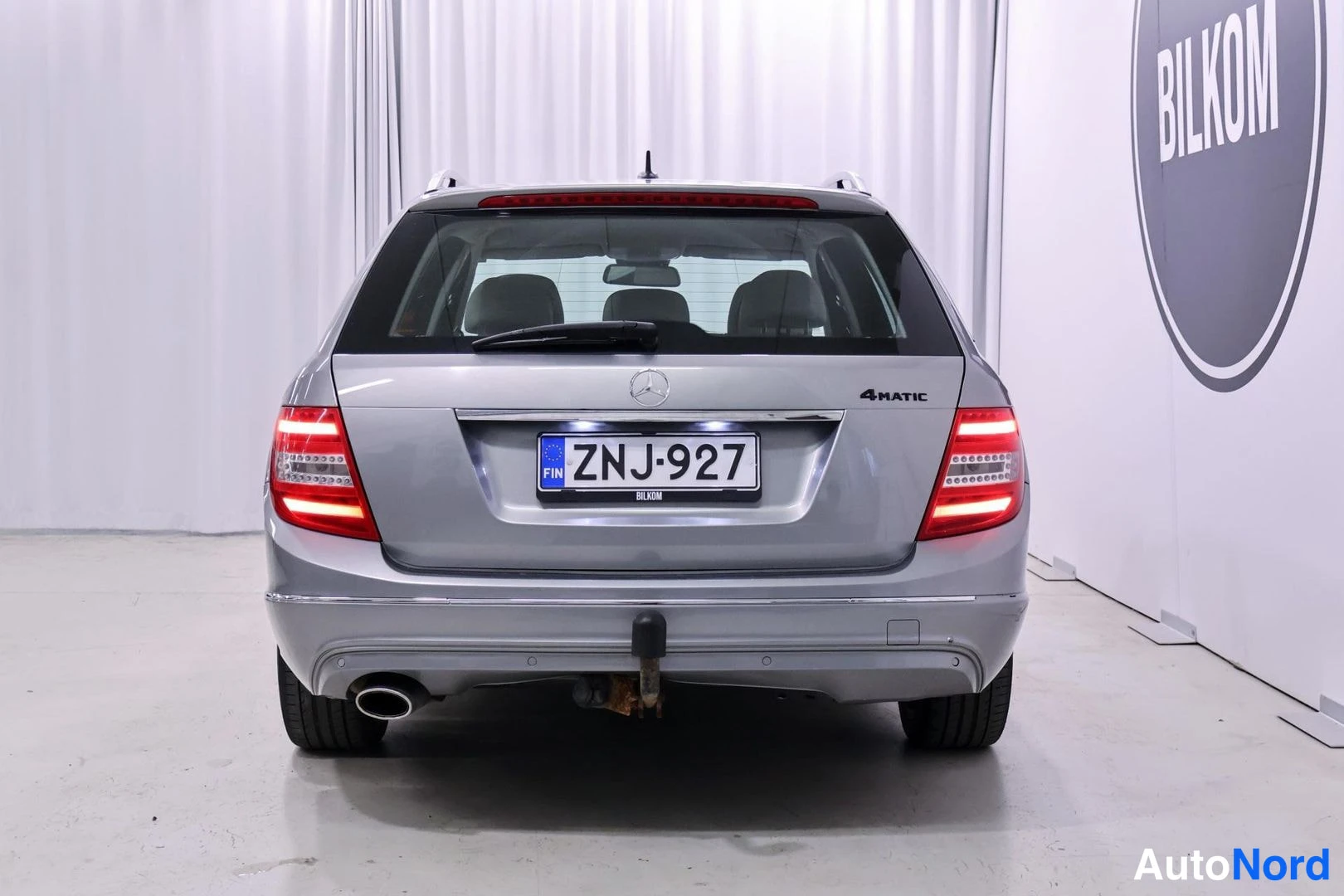 Takaa: Mercedes-Benz C -farmari suoraan takaa, hopeanharmaa takaponttooni, 4MATIC-teksti ja rekisteritunnus.