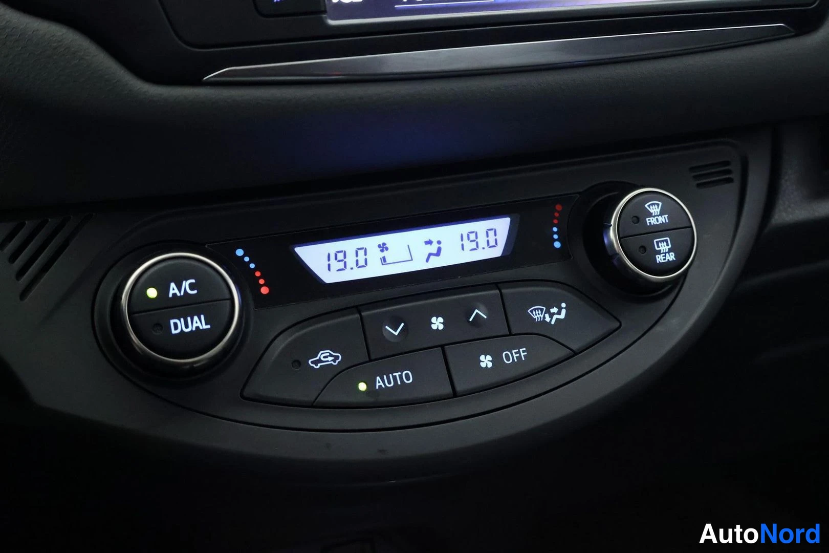 Ohjaamo: Climate control panel showing digital temperature readout of 19.0 degrees and a dual-zone control knob labeled 'DUAL'. An illuminated 'AUTO' button is present.