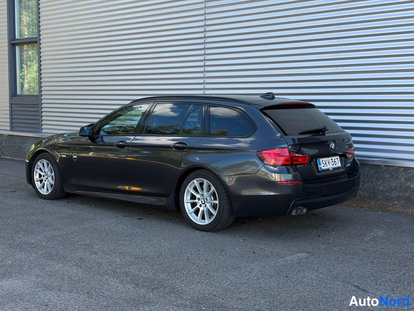 Takaviisto: BMW 520 farmari takaa viistosta, tummanharmaa, rekisterikilpi